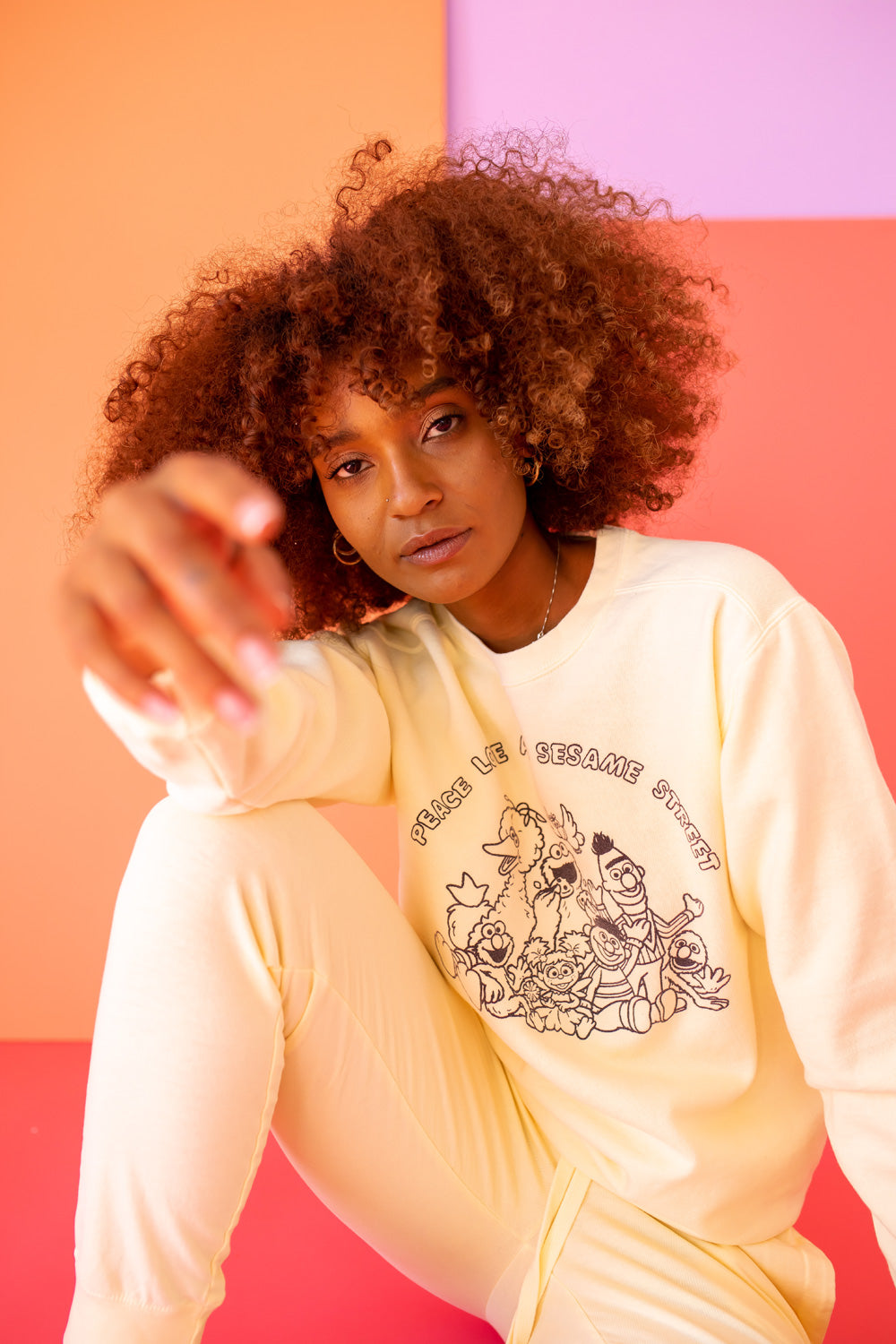 Ivory Peace Love and Sesame Sweatshirt made from 100% upcycled cotton, featuring a playful design that embodies love and peace.