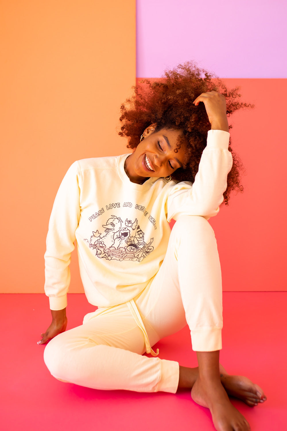 Ivory Peace Love and Sesame Sweatshirt made from 100% upcycled cotton, featuring a playful design that embodies love and peace.