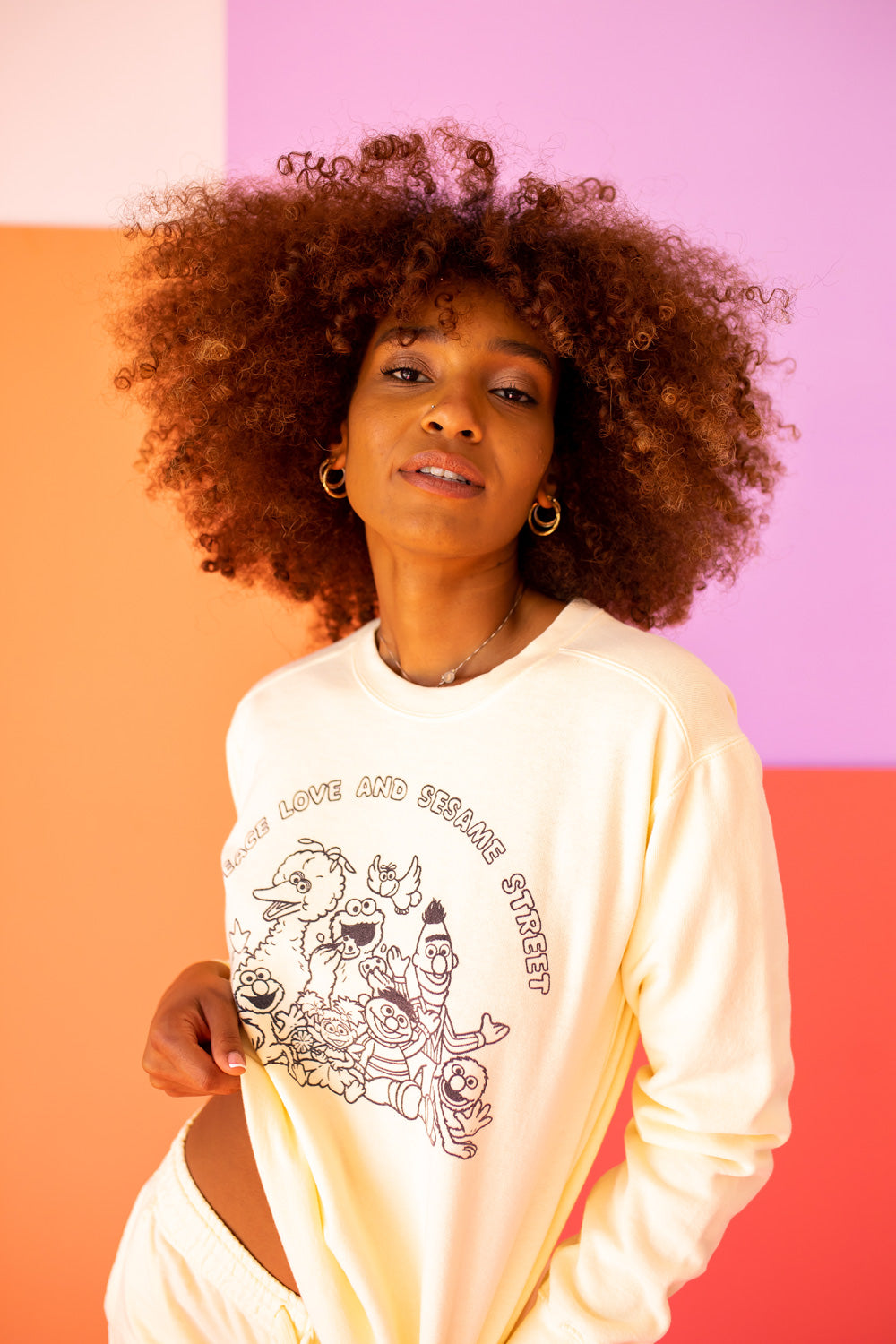 Ivory Peace Love and Sesame Sweatshirt made from 100% upcycled cotton, featuring a playful design that embodies love and peace.