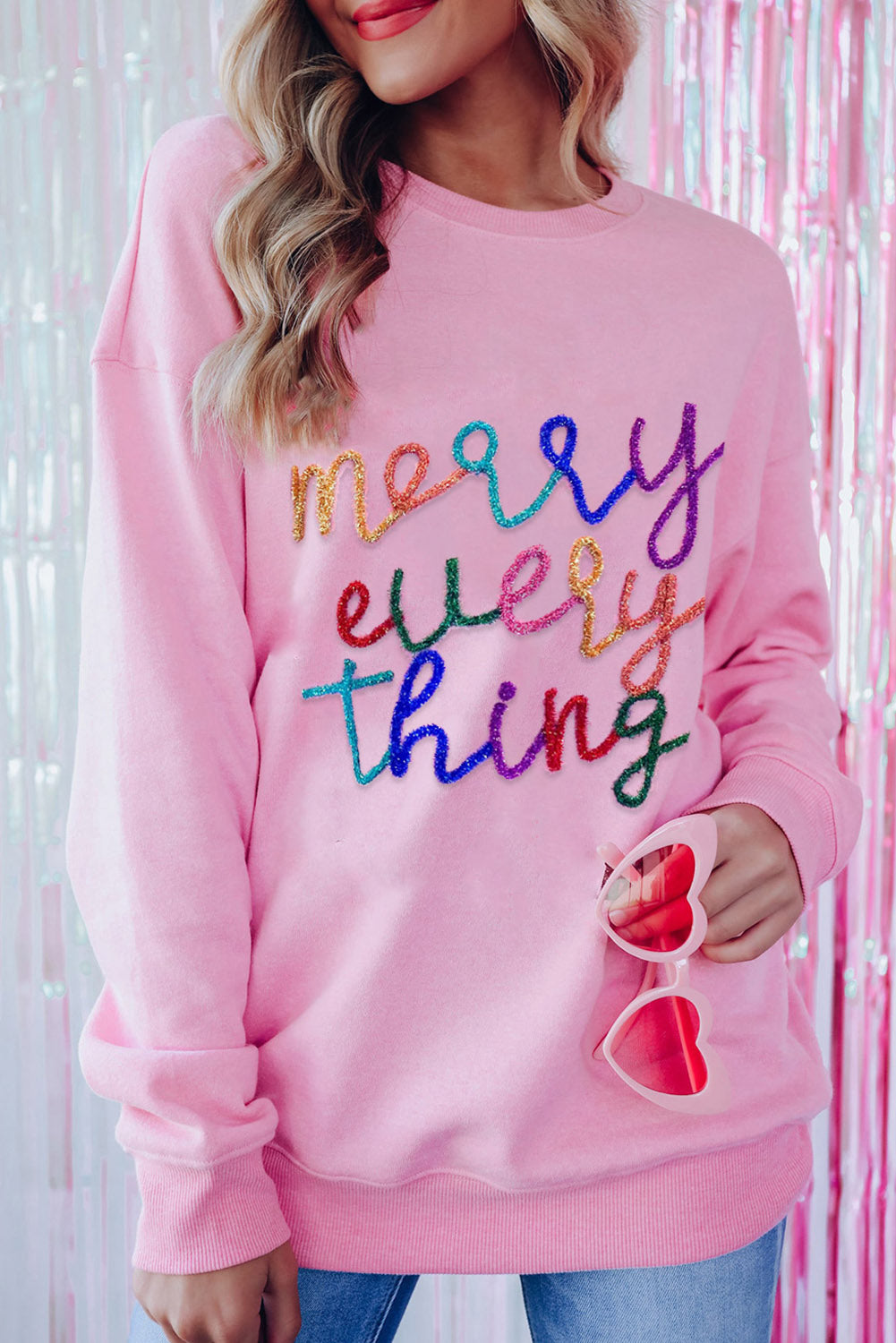 Peach Blossom Merry Every Thing Glitter Slogan Sweatshirt featuring a relaxed fit, drop shoulders, and playful glitter graphics.