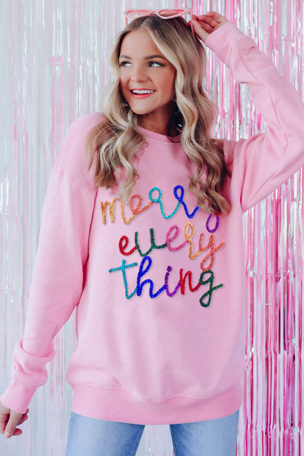 Peach Blossom Merry Every Thing Glitter Slogan Sweatshirt featuring a relaxed fit, drop shoulders, and playful glitter graphics.