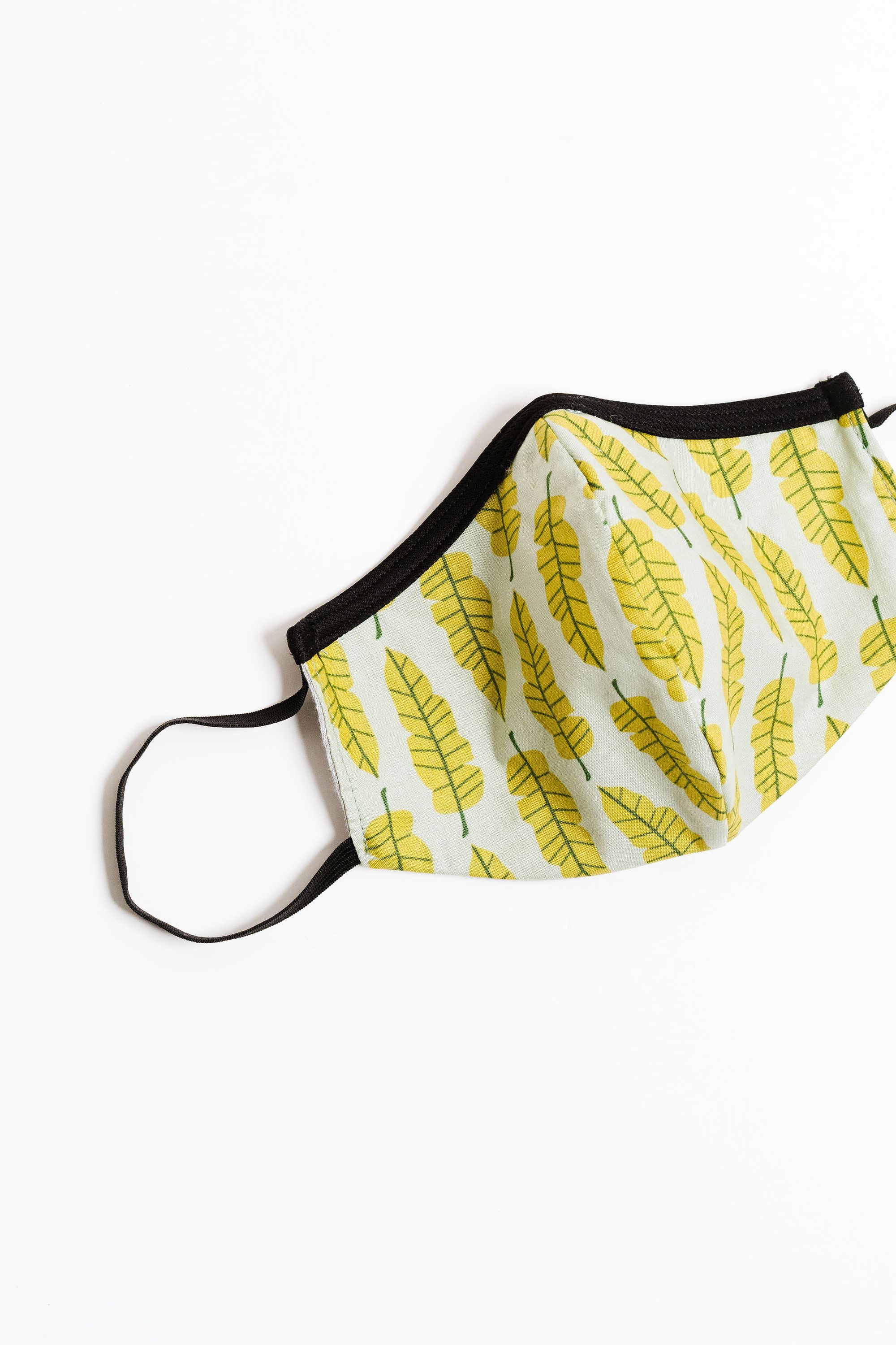 Philodendron Face Mask made of 100% cotton with unique printed designs, featuring elastic straps for a secure fit.