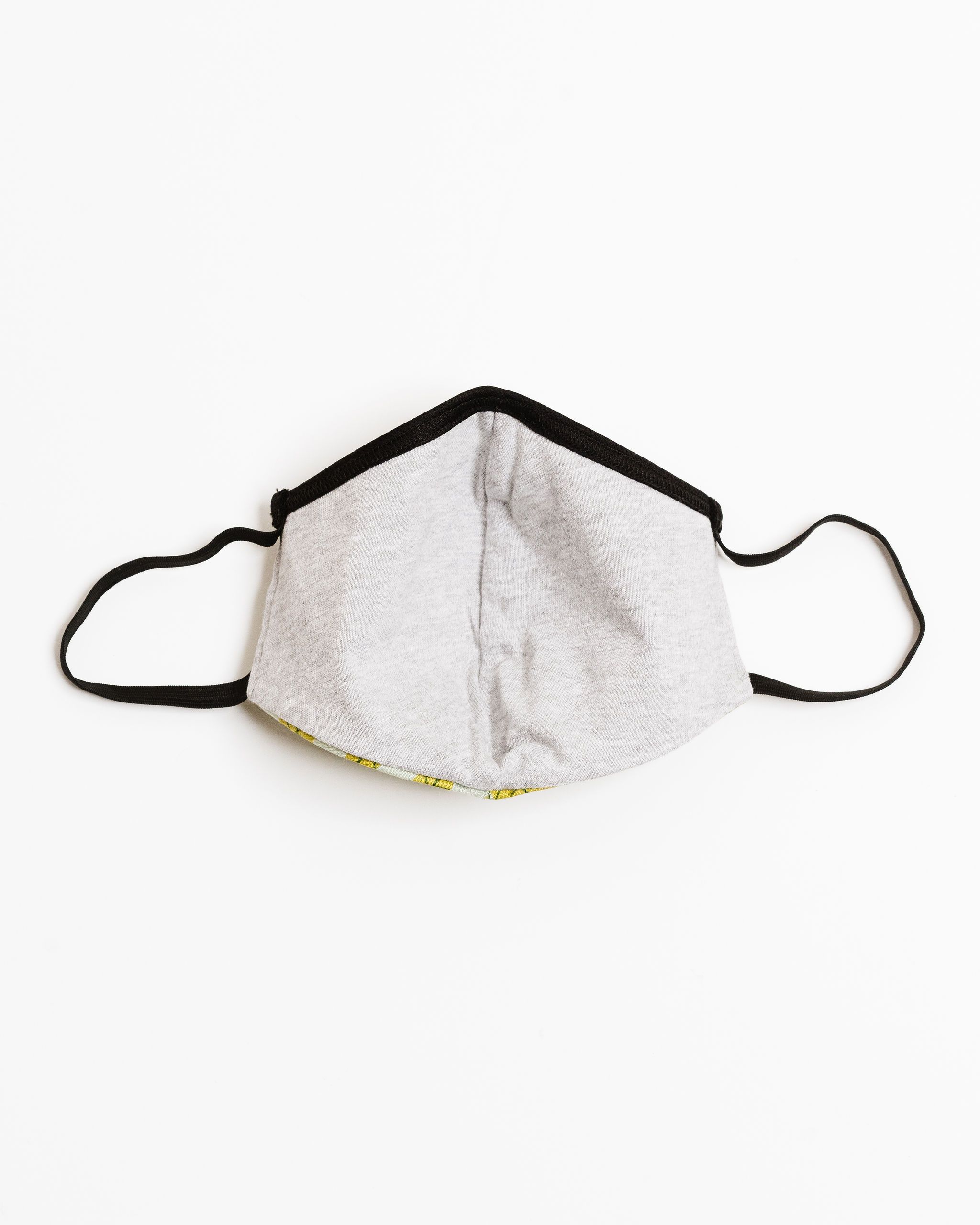 Philodendron Face Mask made of 100% cotton with unique printed designs, featuring elastic straps for a secure fit.