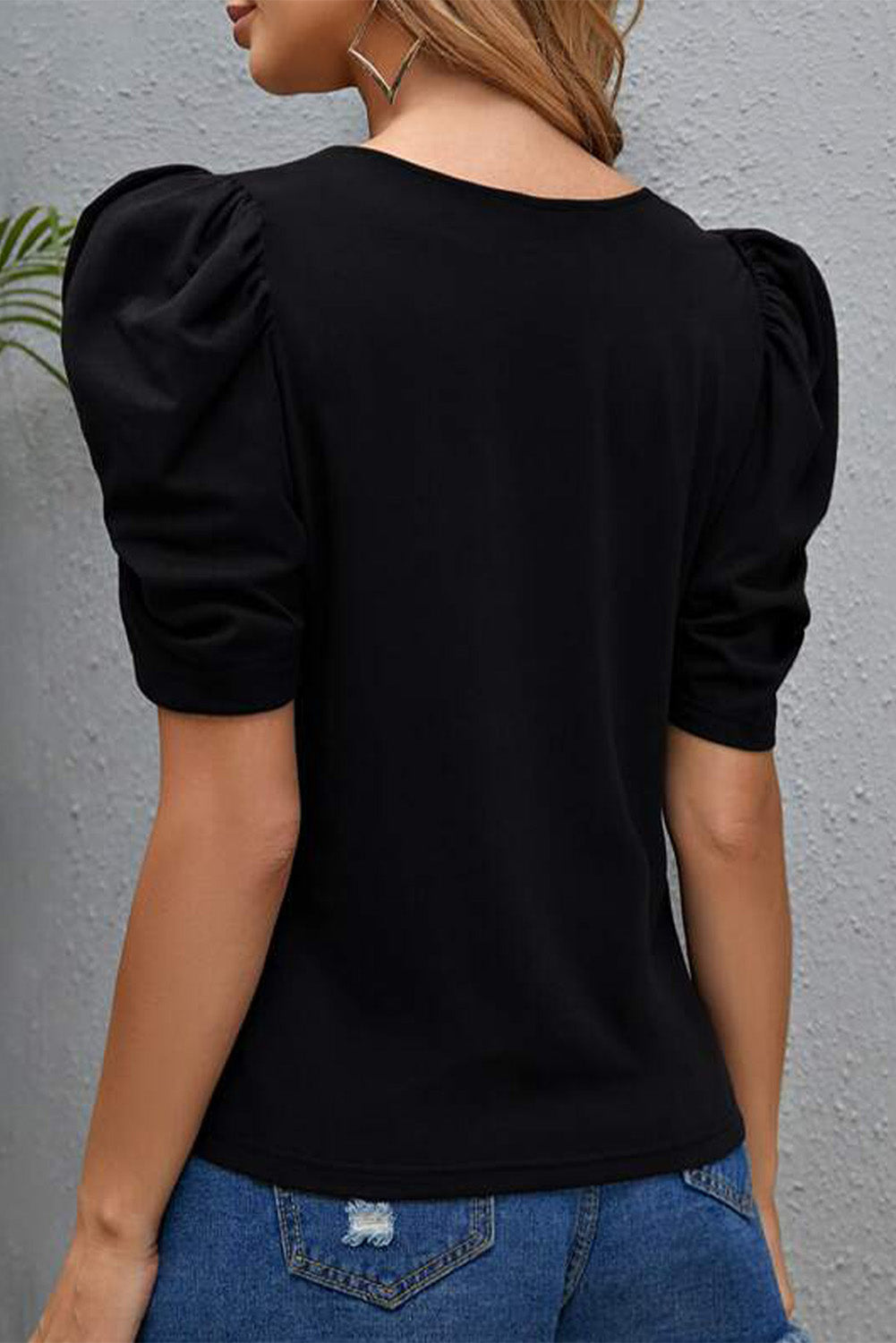 A stylish pink top featuring a heart shape print and short puff sleeves, perfect for casual outings.