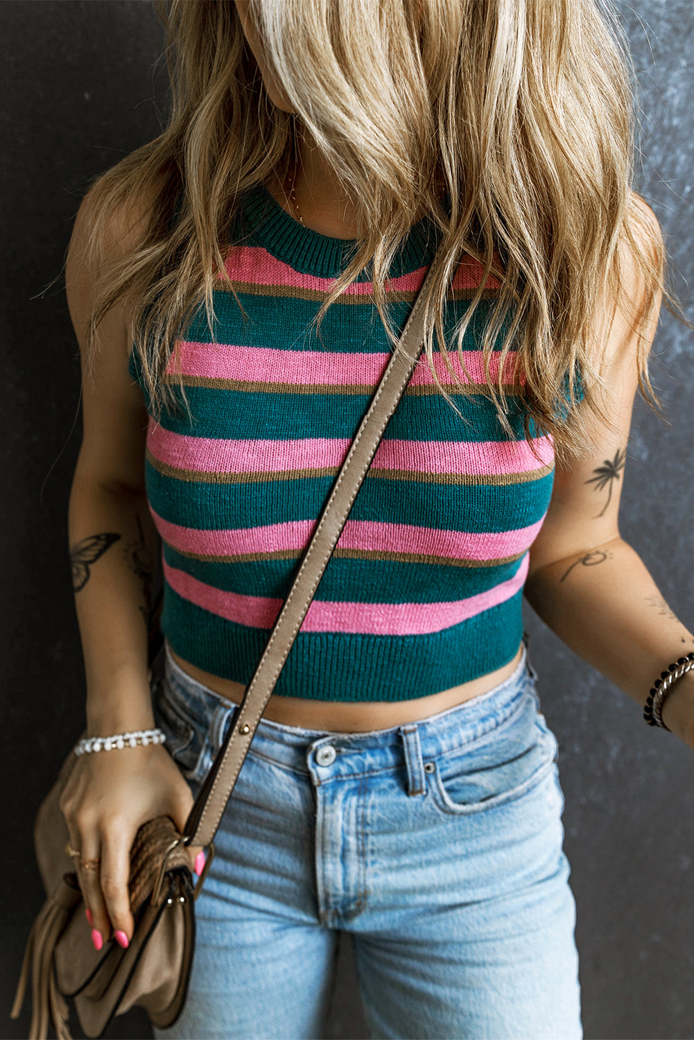 A stylish pink stripe sleeveless knit cropped sweater top displayed on a mannequin, showcasing its chic design and comfortable fit.