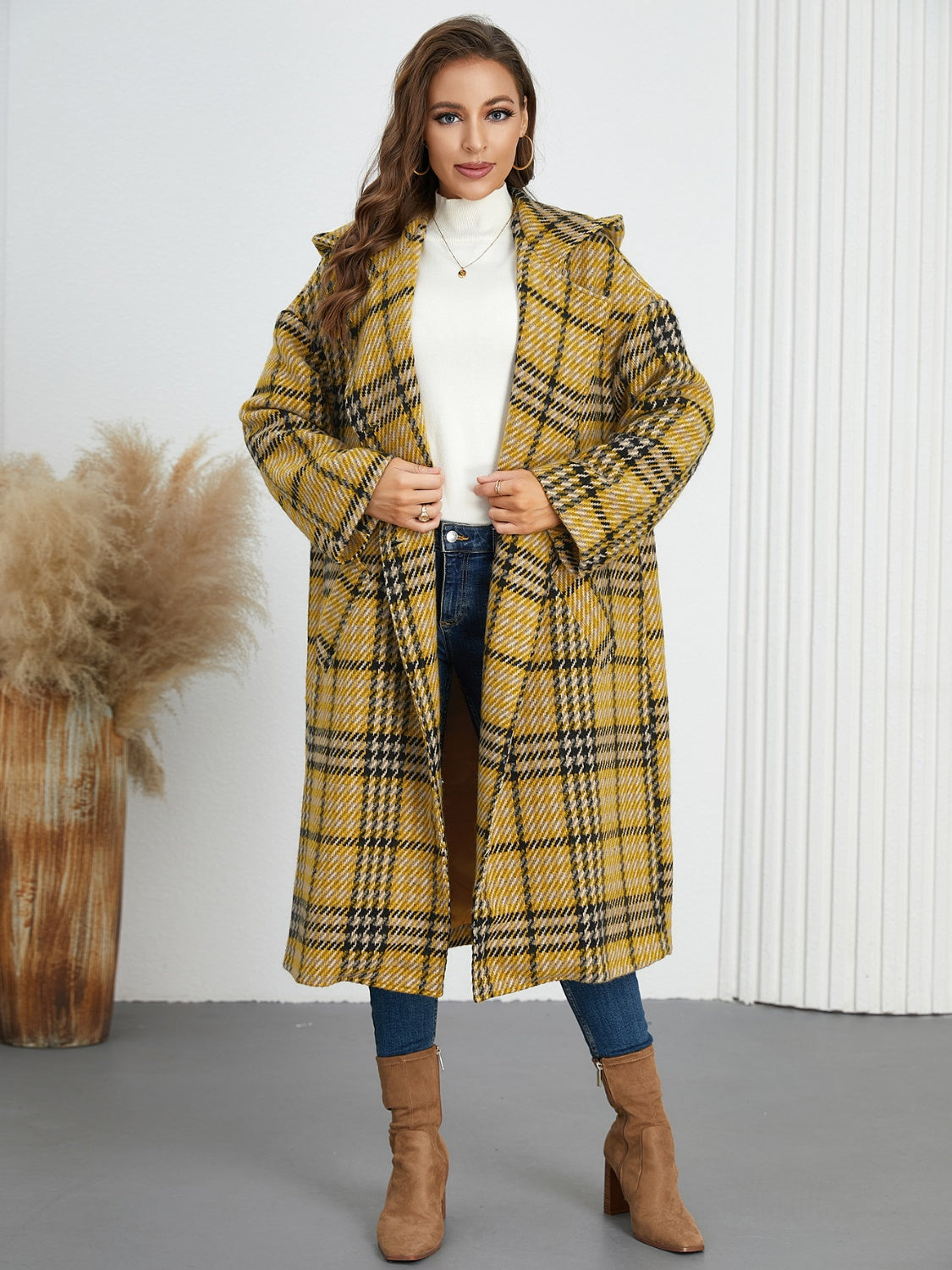 Plaid double-breasted long sleeve longline coat displayed on a mannequin, showcasing its stylish design and buttoned front.