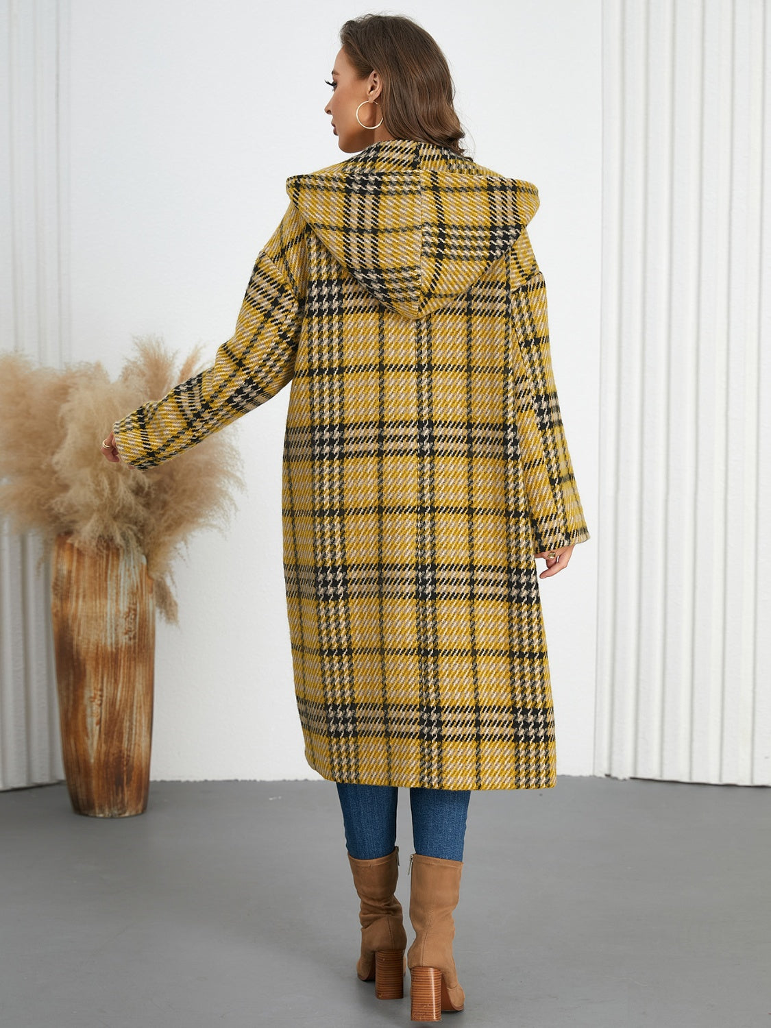Plaid double-breasted long sleeve longline coat displayed on a mannequin, showcasing its stylish design and buttoned front.