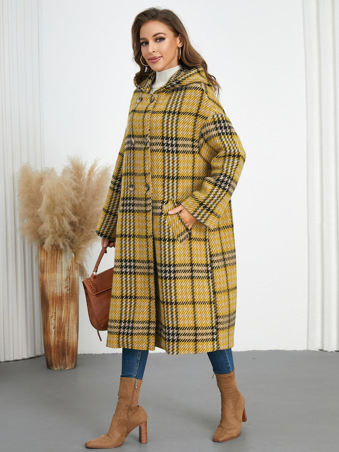 Plaid double-breasted long sleeve longline coat displayed on a mannequin, showcasing its stylish design and buttoned front.