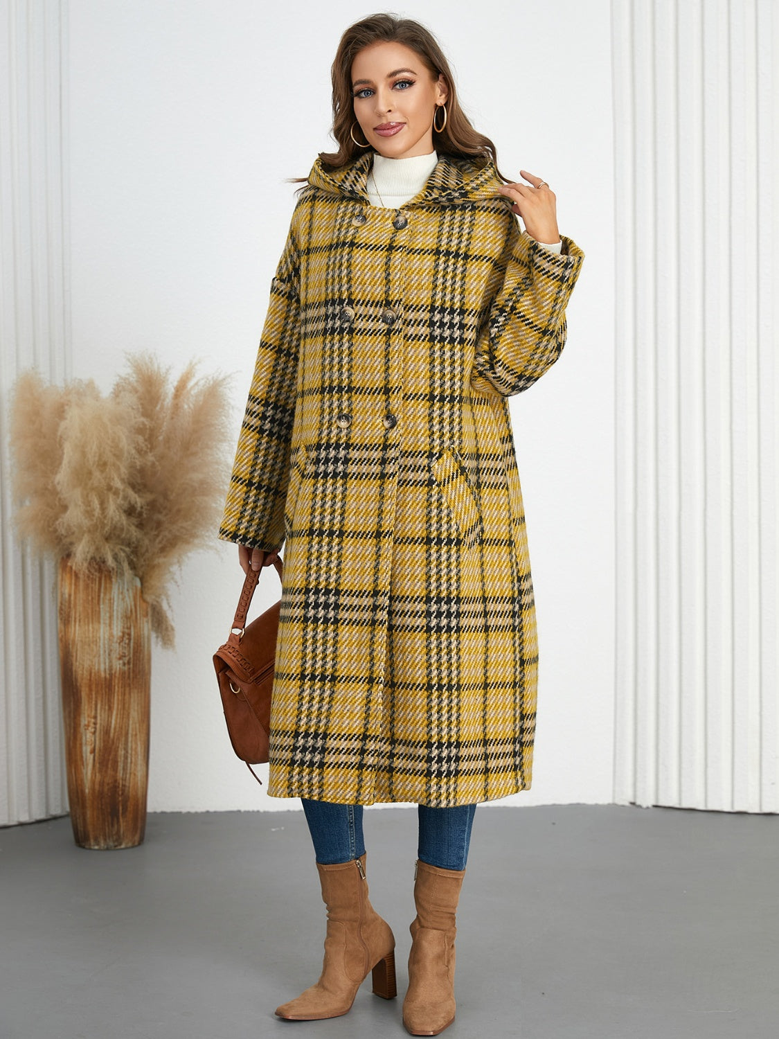 Plaid double-breasted long sleeve longline coat displayed on a mannequin, showcasing its stylish design and buttoned front.