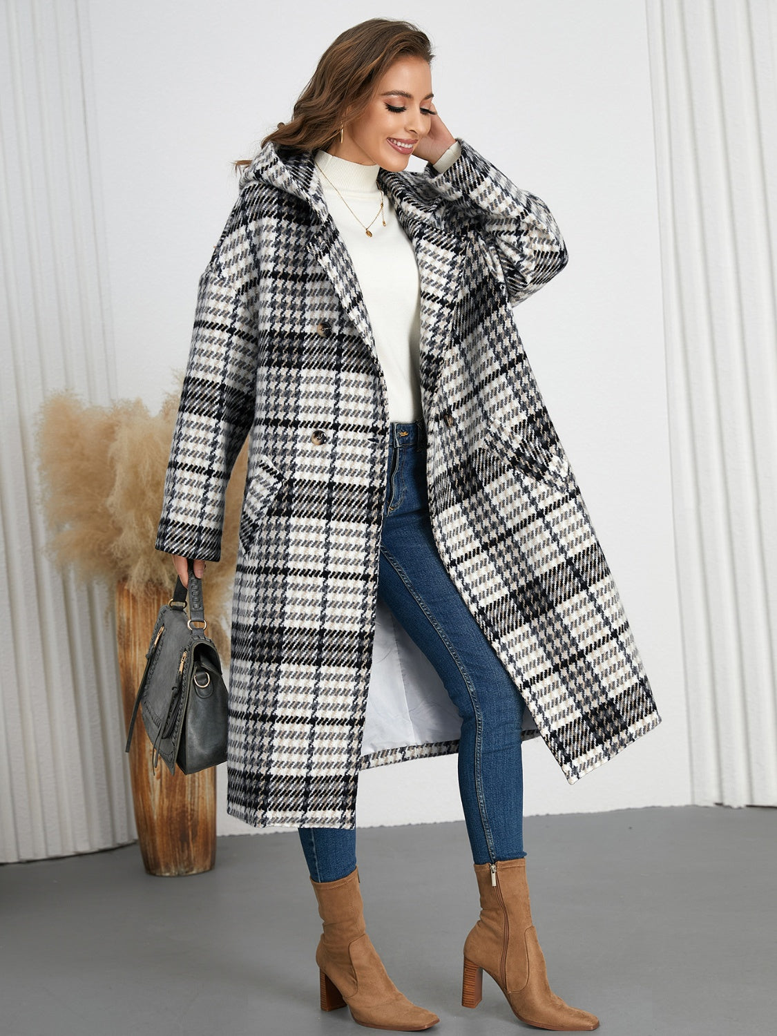 Plaid double-breasted long sleeve longline coat displayed on a mannequin, showcasing its stylish design and buttoned front.