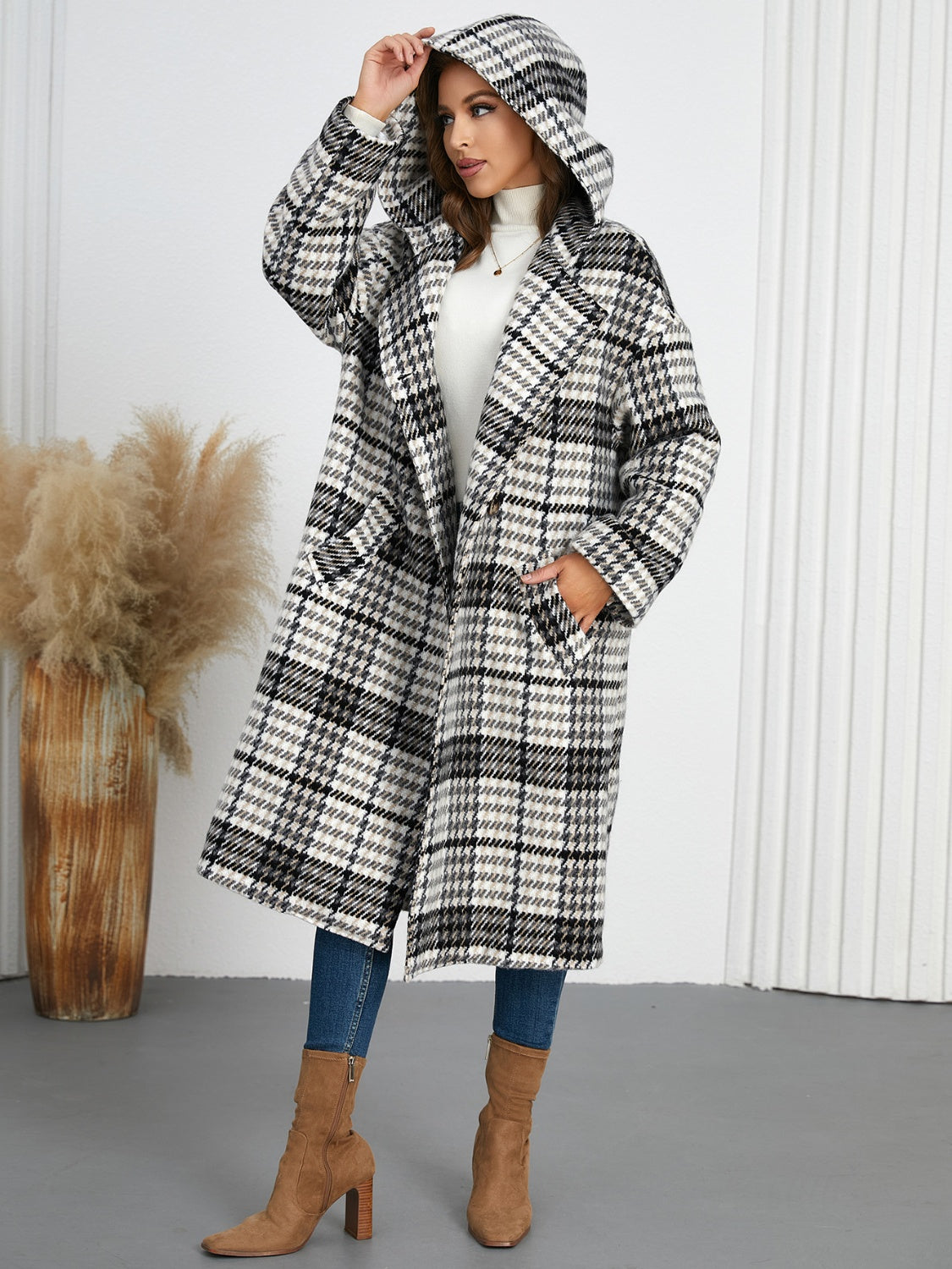 Plaid double-breasted long sleeve longline coat displayed on a mannequin, showcasing its stylish design and buttoned front.