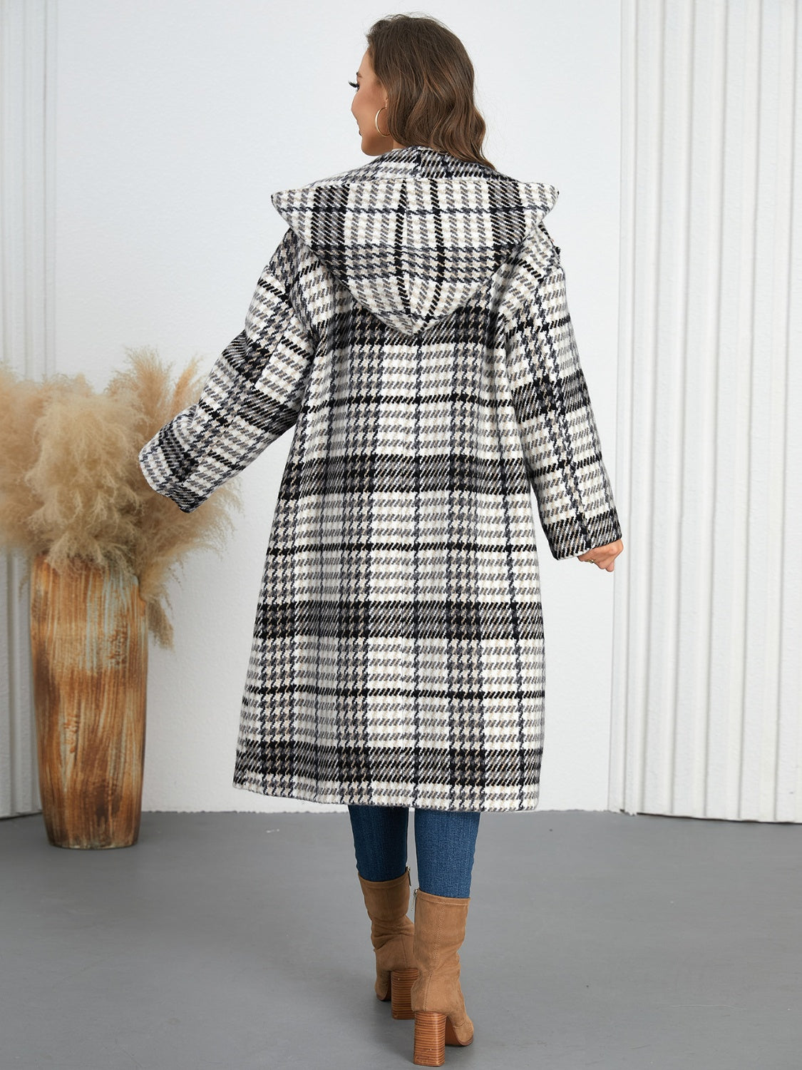 Plaid double-breasted long sleeve longline coat displayed on a mannequin, showcasing its stylish design and buttoned front.