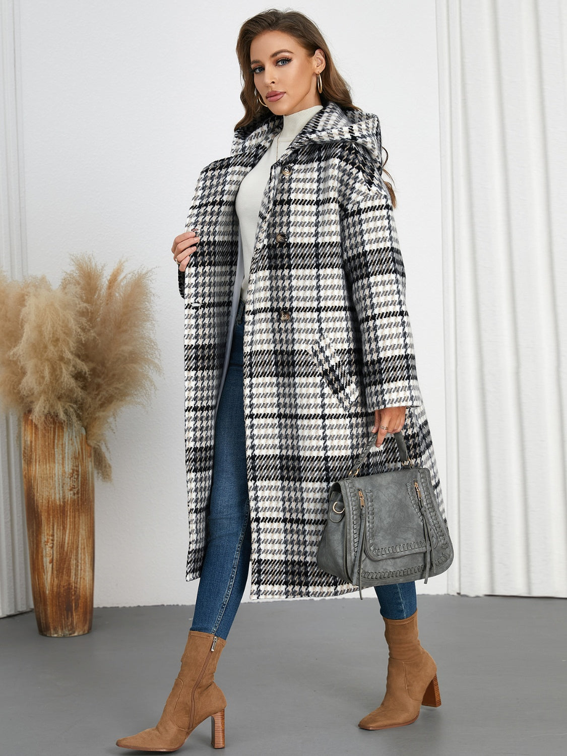 Plaid double-breasted long sleeve longline coat displayed on a mannequin, showcasing its stylish design and buttoned front.