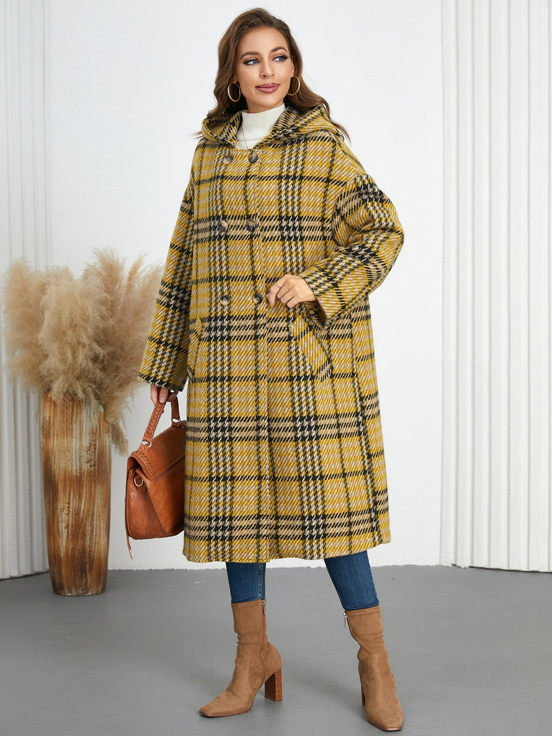 Plaid double-breasted long sleeve longline coat displayed on a mannequin, showcasing its stylish design and buttoned front.