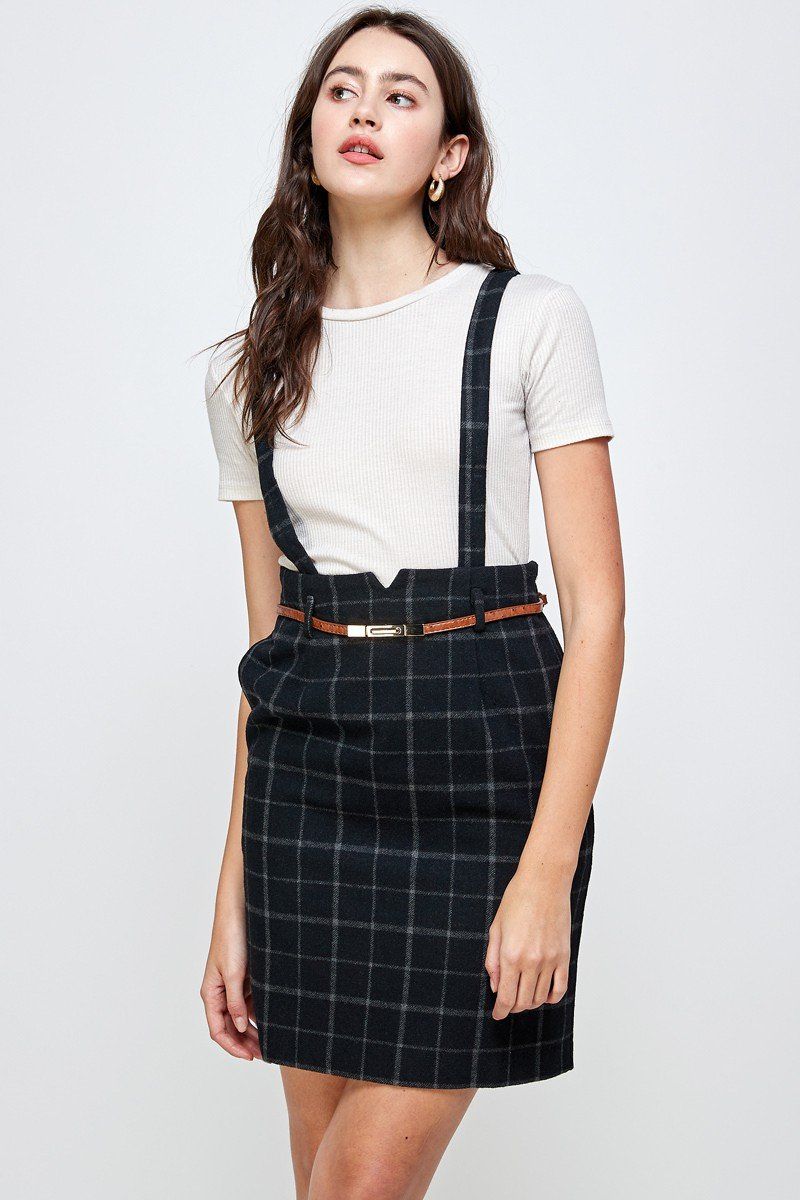 A stylish suspender high waisted skirt displayed on a model, showcasing its trendy design and flattering fit.