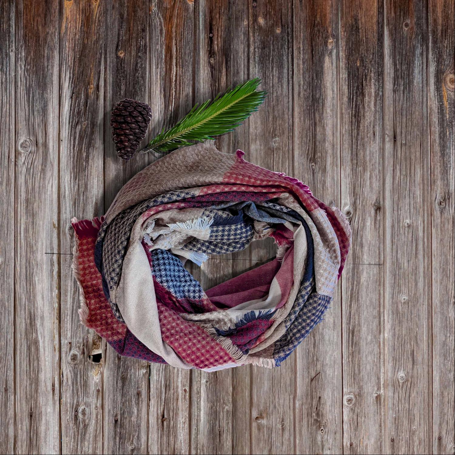 A cozy plaid waffle knit blanket scarf in vibrant fall colors, draped elegantly.