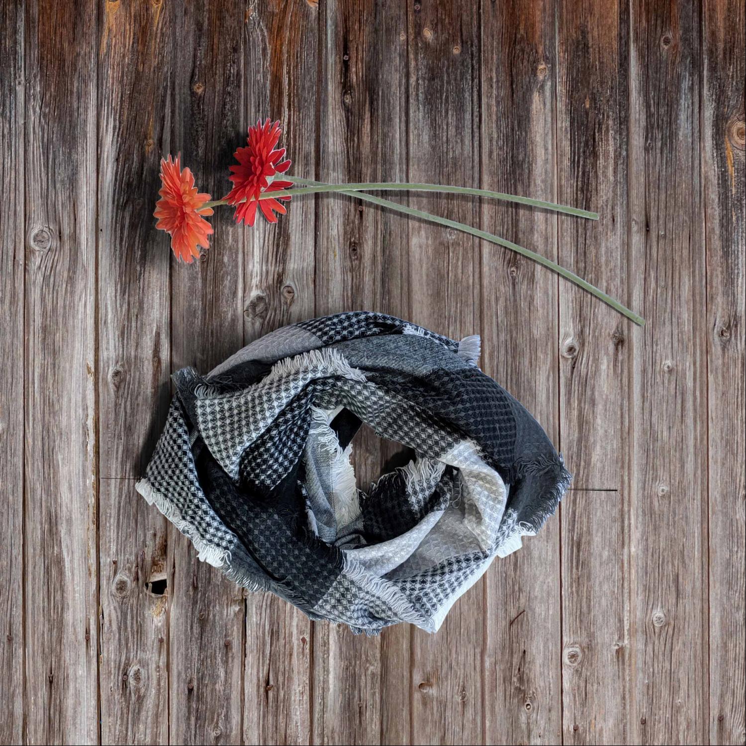 A cozy plaid waffle knit blanket scarf in vibrant fall colors, draped elegantly.