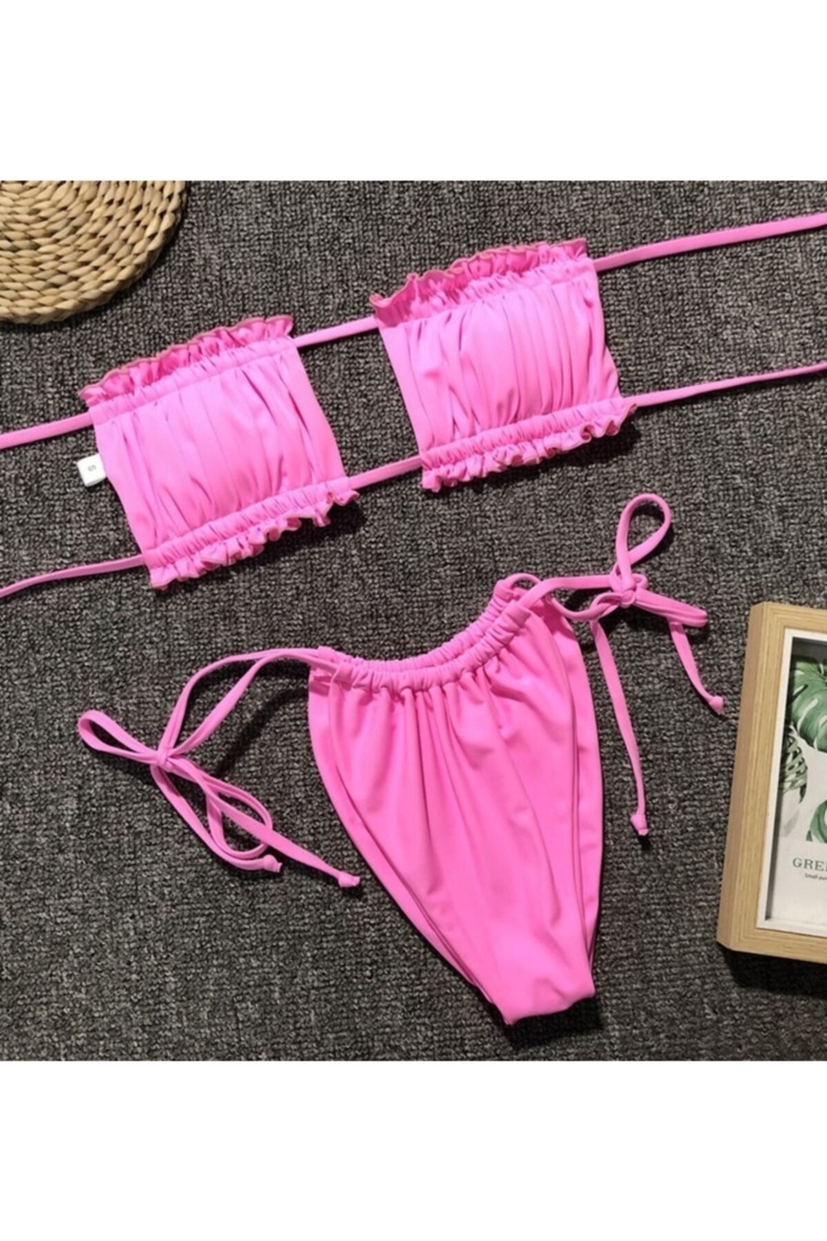 A stylish pleated pink Brazilian bikini set featuring a cheeky cut, perfect for summer pool parties and beach outings.