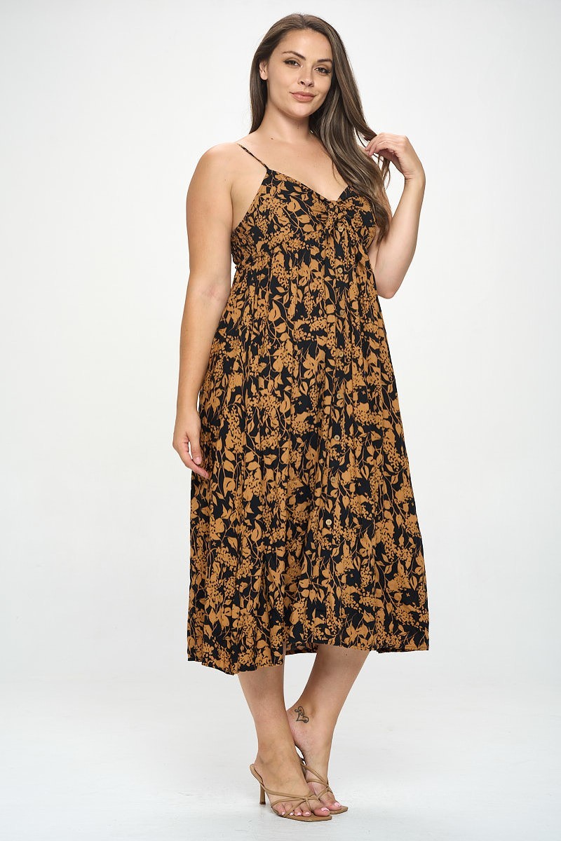 A stylish plus-size maxi dress featuring a botanical print and a front tie detail, perfect for various occasions.
