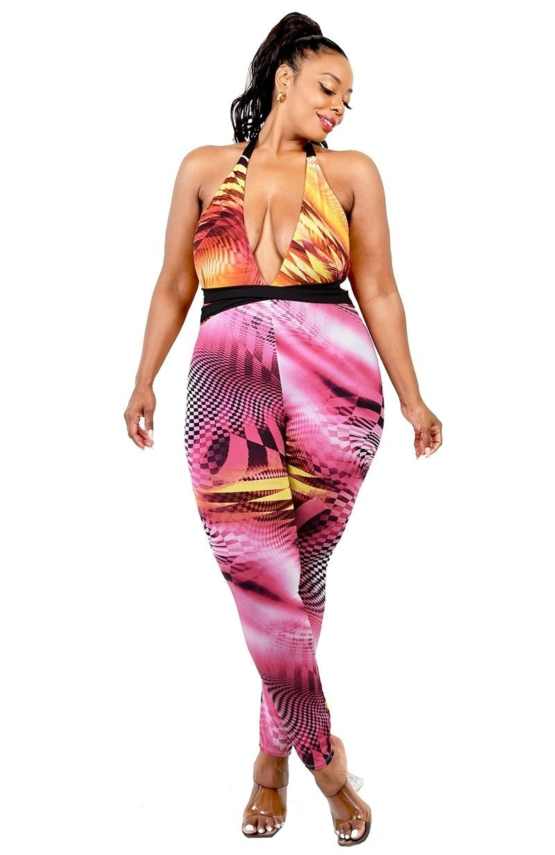 Plus size jumpsuit featuring criss cross halter neck, cutout design, and vibrant fuchsia and yellow colors.