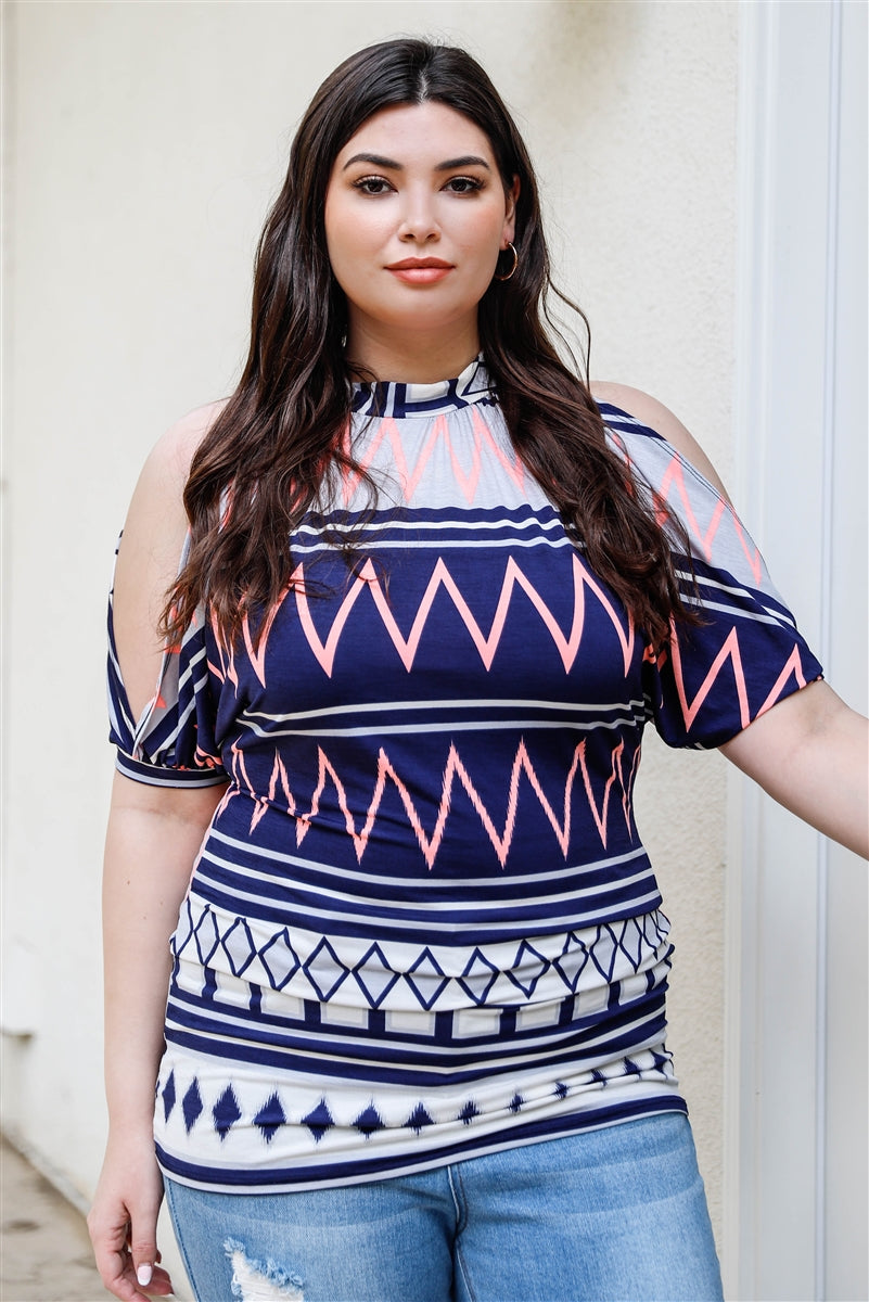 A stylish plus size cold shoulder top featuring a navy polka dot print, short cuffed sleeves, and a back self-tie detail, perfect for casual outings.