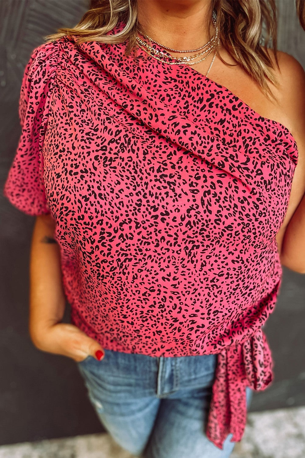 Plus size pink leopard print top with one sleeve and decorative knot detail, showcasing an asymmetric neckline.