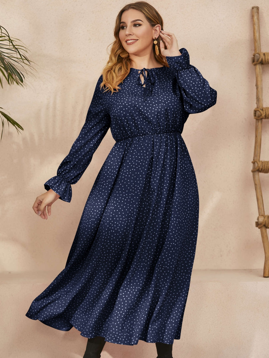 A stylish plus size ruffled polka dot long sleeve midi dress, featuring a playful polka dot pattern and elegant ruffles, perfect for any occasion.