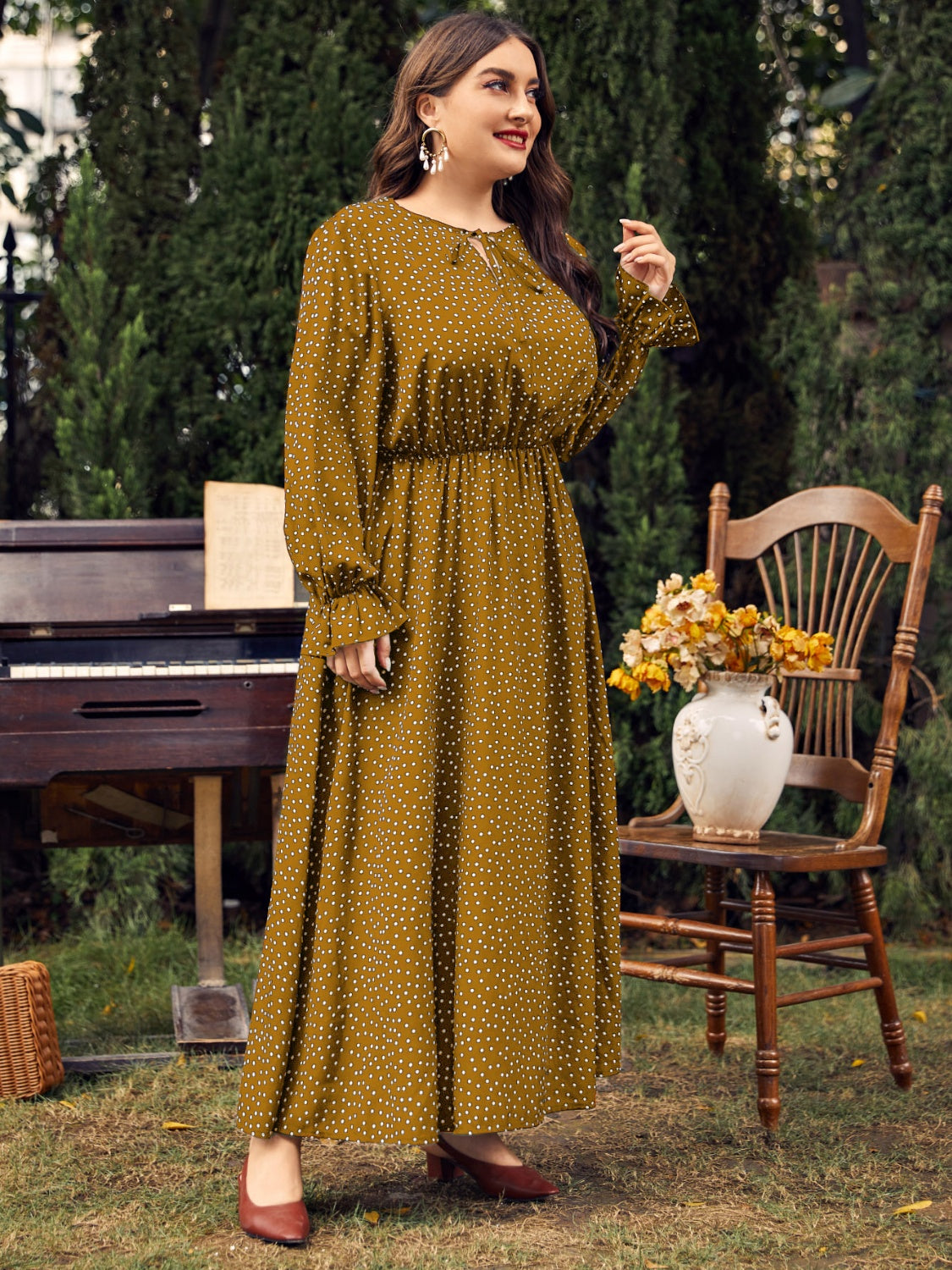 A stylish plus size ruffled polka dot long sleeve midi dress, featuring a playful polka dot pattern and elegant ruffles, perfect for any occasion.