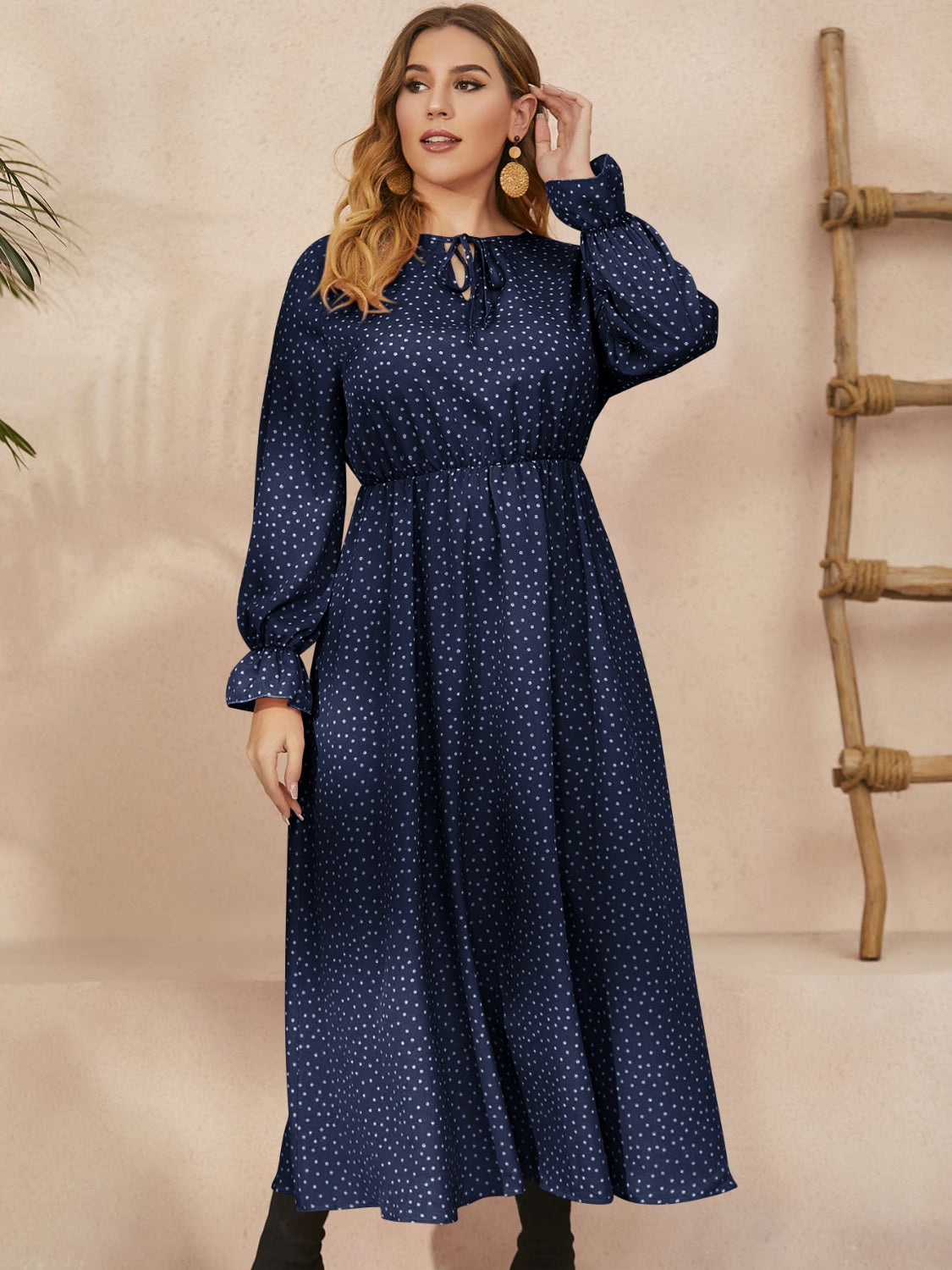 A stylish plus size ruffled polka dot long sleeve midi dress, featuring a playful polka dot pattern and elegant ruffles, perfect for any occasion.