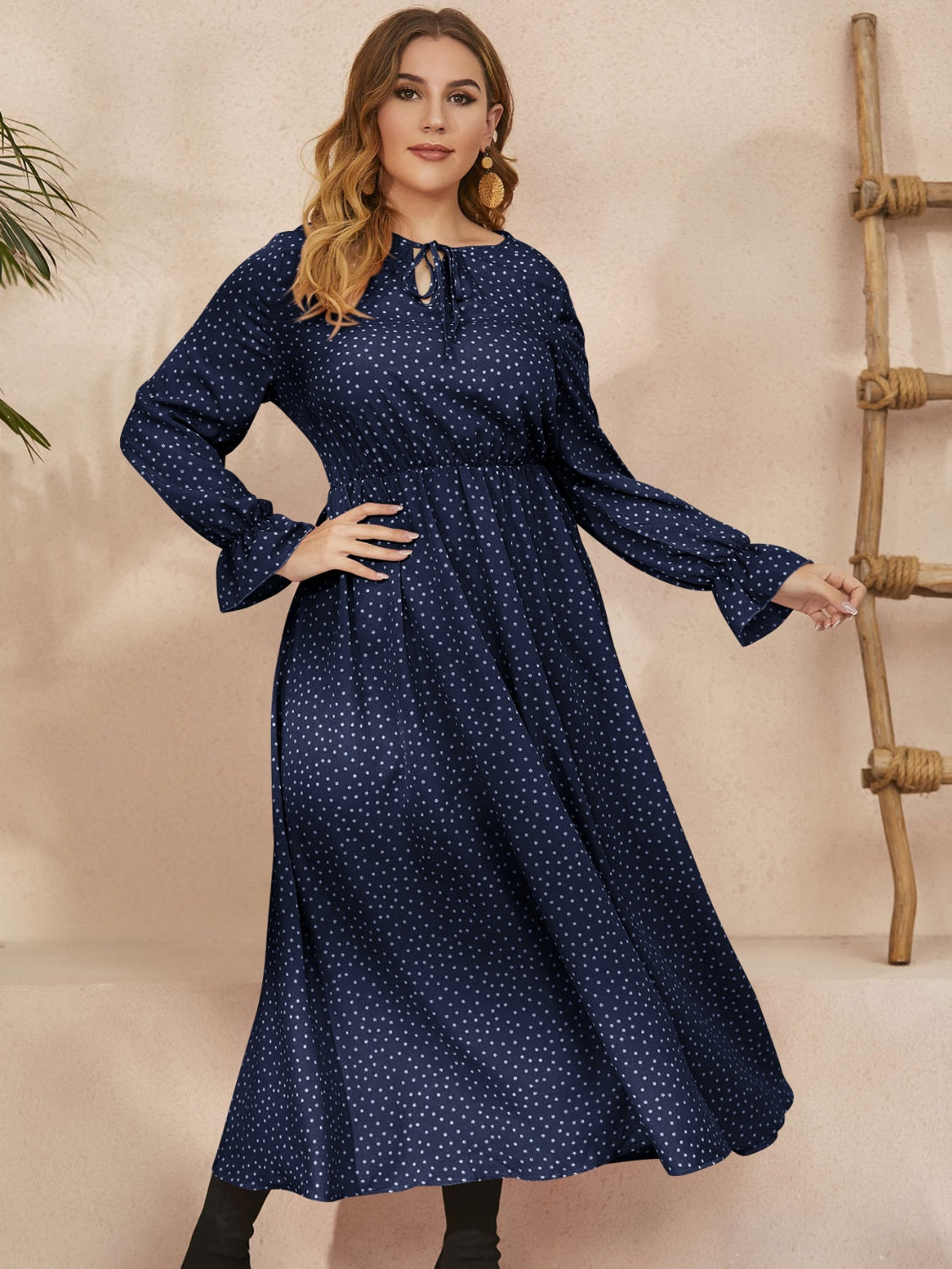A stylish plus size ruffled polka dot long sleeve midi dress, featuring a playful polka dot pattern and elegant ruffles, perfect for any occasion.