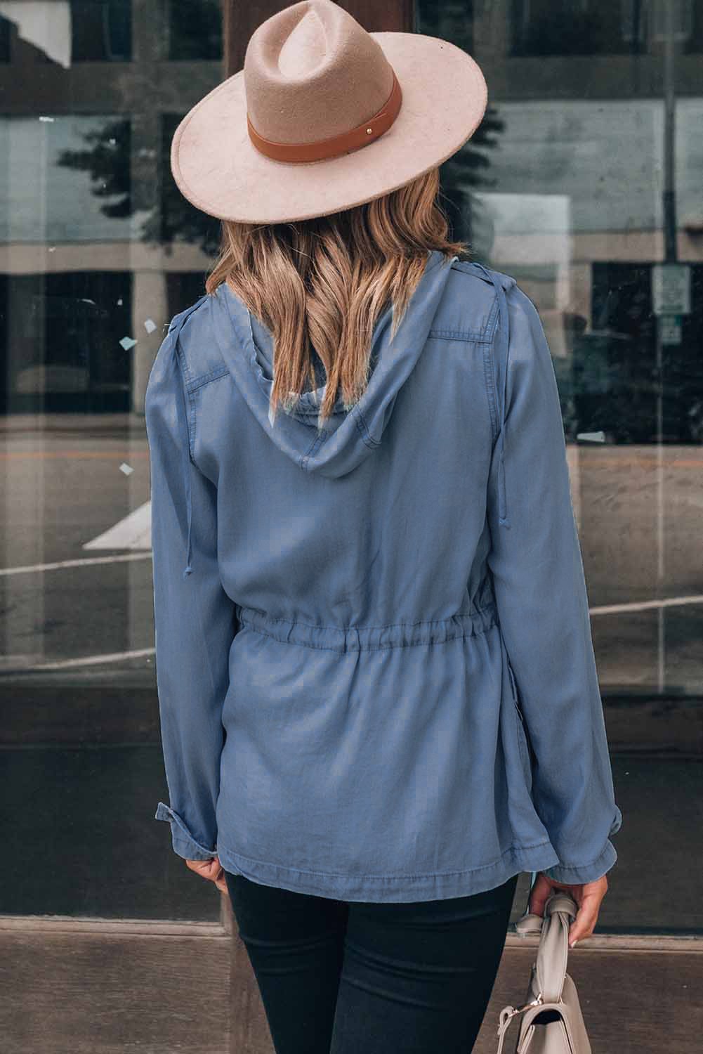 A stylish hooded jacket featuring a front zipper, button closure, and drawstring waistline, perfect for chilly weather.