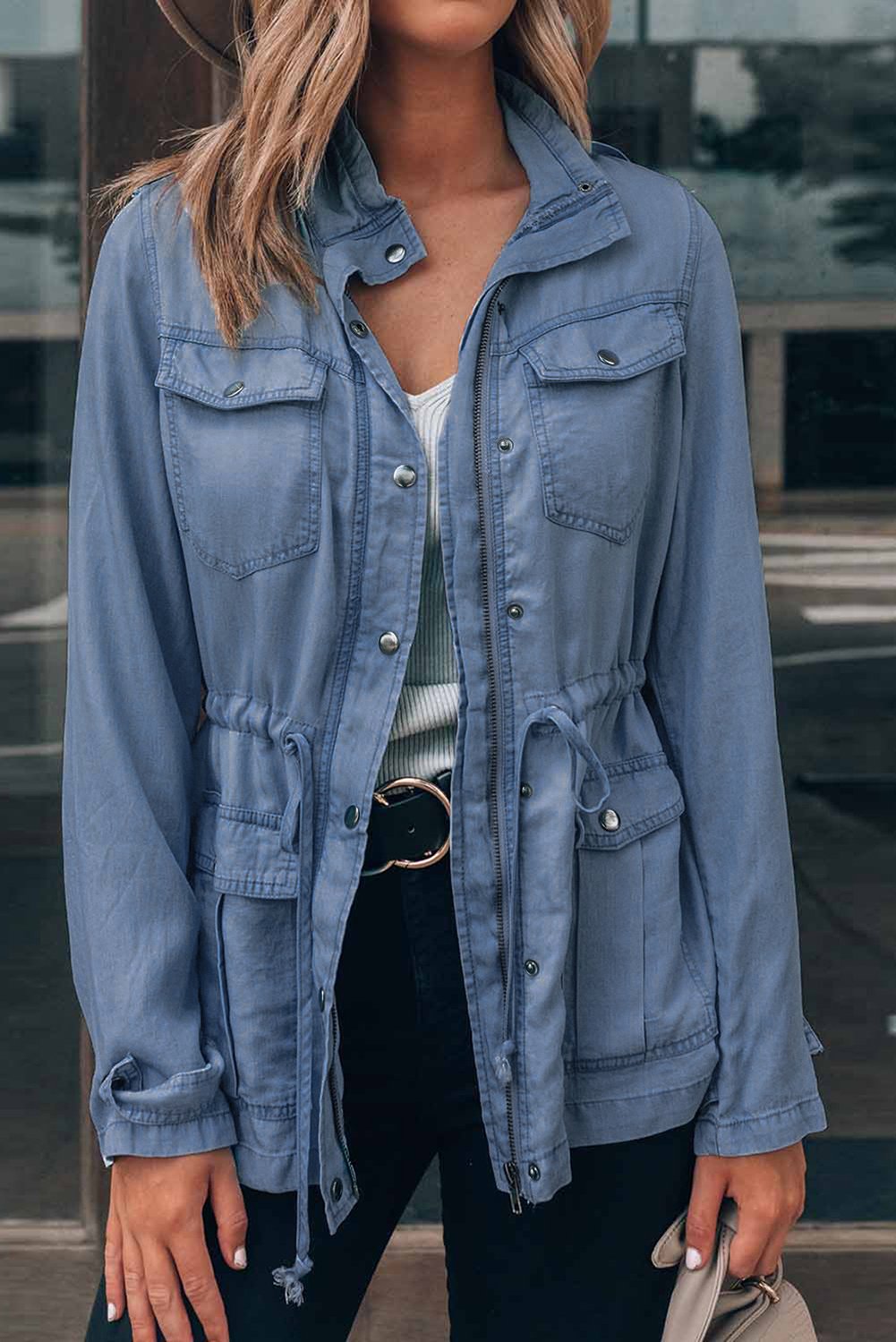 A stylish hooded jacket featuring a front zipper, button closure, and drawstring waistline, perfect for chilly weather.