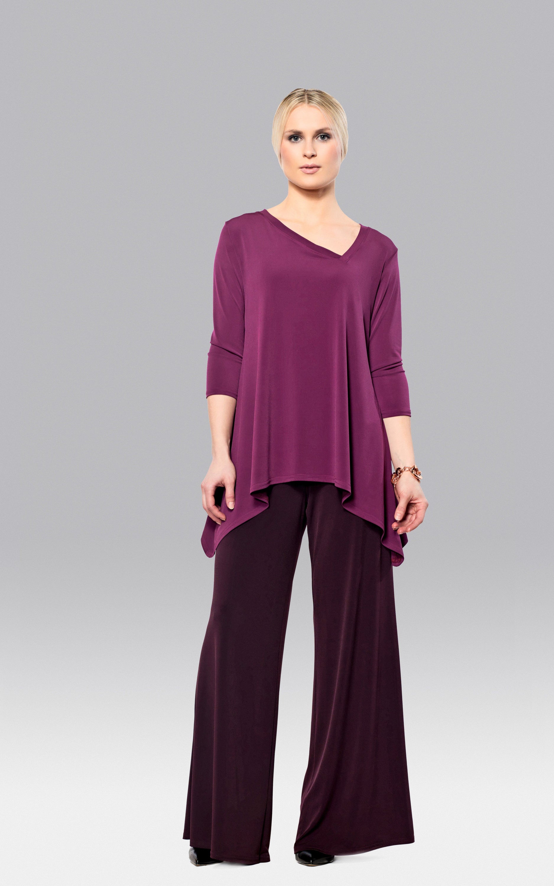 A stylish Pointed Tunic featuring an asymmetrical neckline, made from a comfortable polyester and spandex blend.