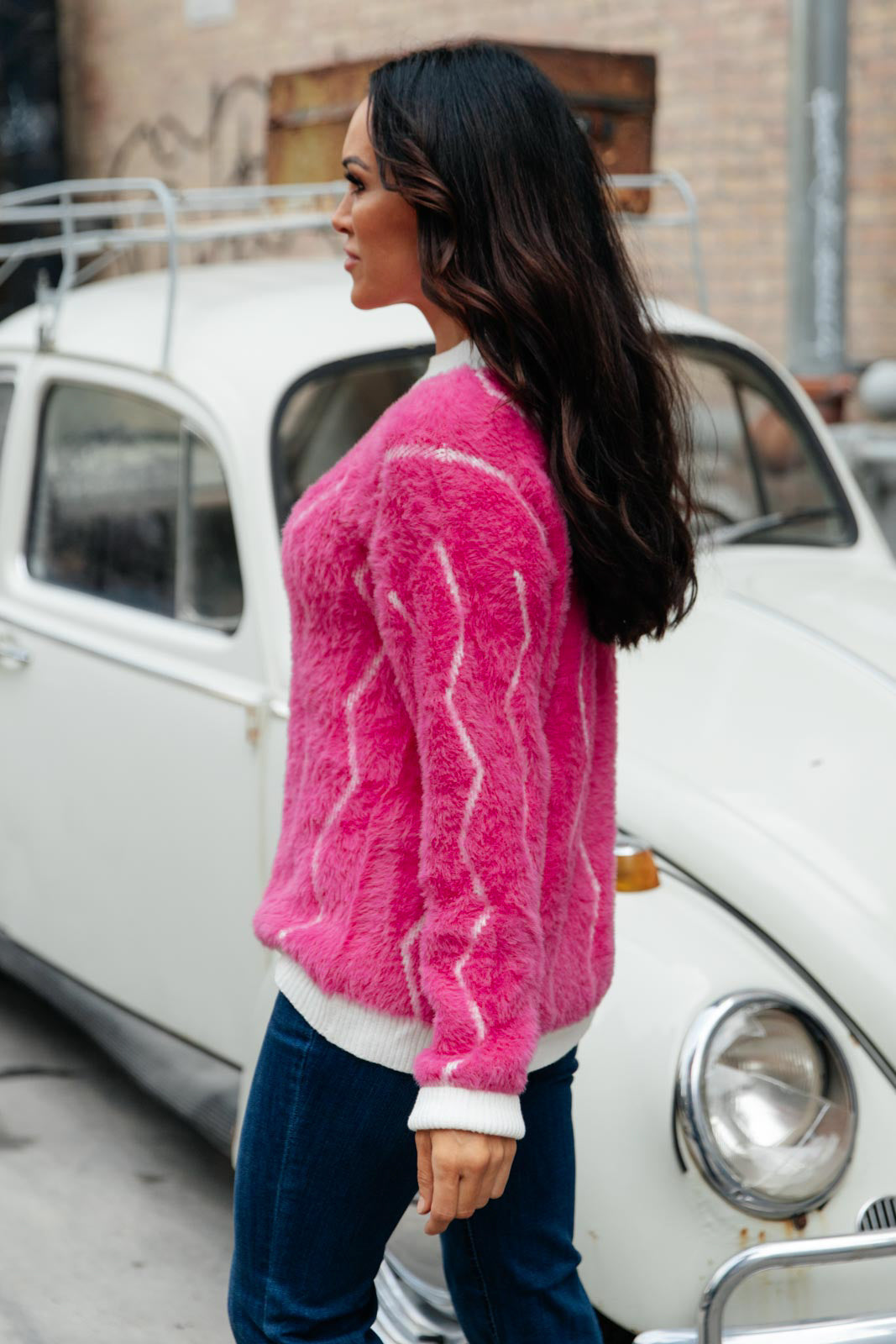 Bright pink Pop Culture Zig Zag Sweater with white collar and cuffs, displayed on a mannequin.