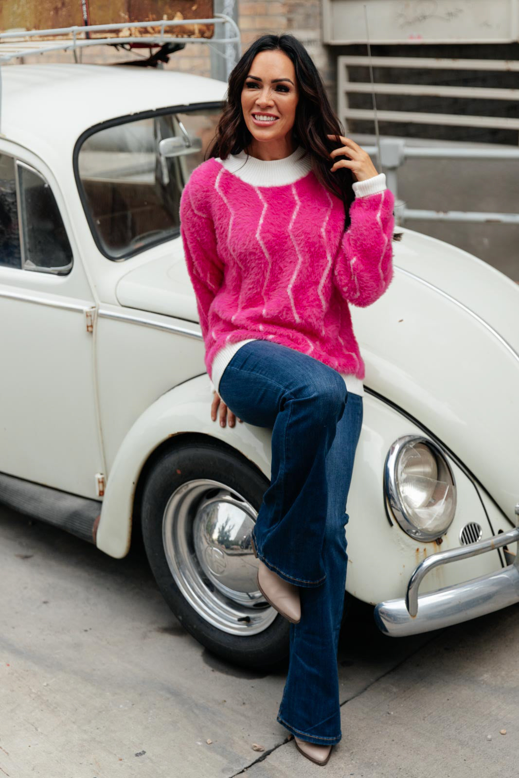 Bright pink Pop Culture Zig Zag Sweater with white collar and cuffs, displayed on a mannequin.