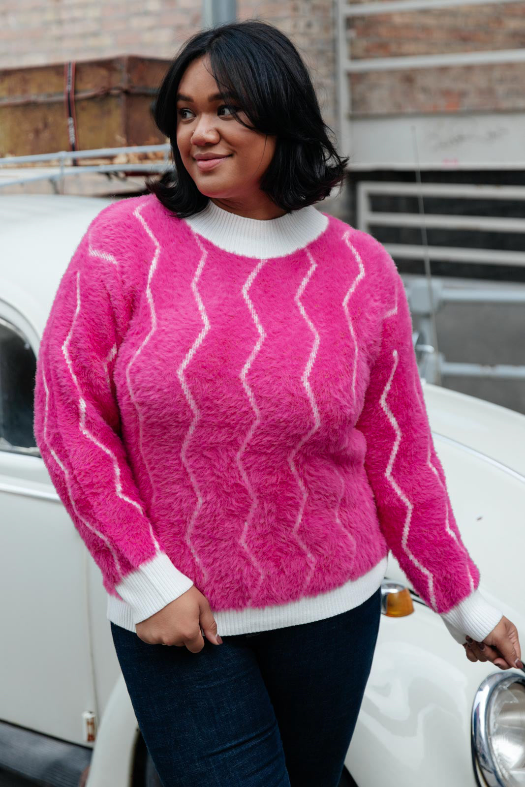 Bright pink Pop Culture Zig Zag Sweater with white collar and cuffs, displayed on a mannequin.