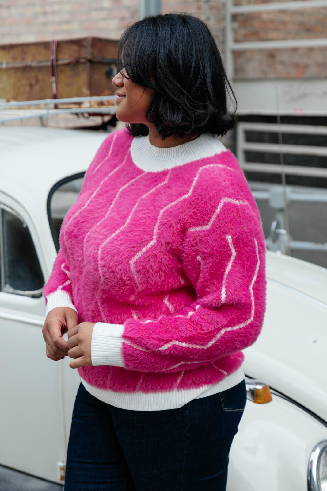 Bright pink Pop Culture Zig Zag Sweater with white collar and cuffs, displayed on a mannequin.