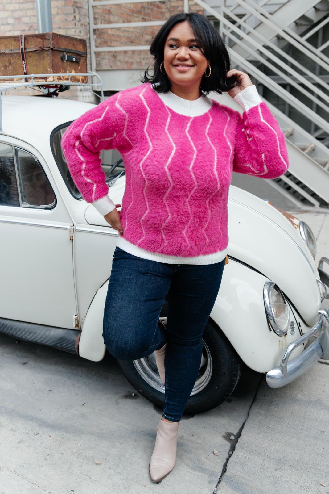 Bright pink Pop Culture Zig Zag Sweater with white collar and cuffs, displayed on a mannequin.