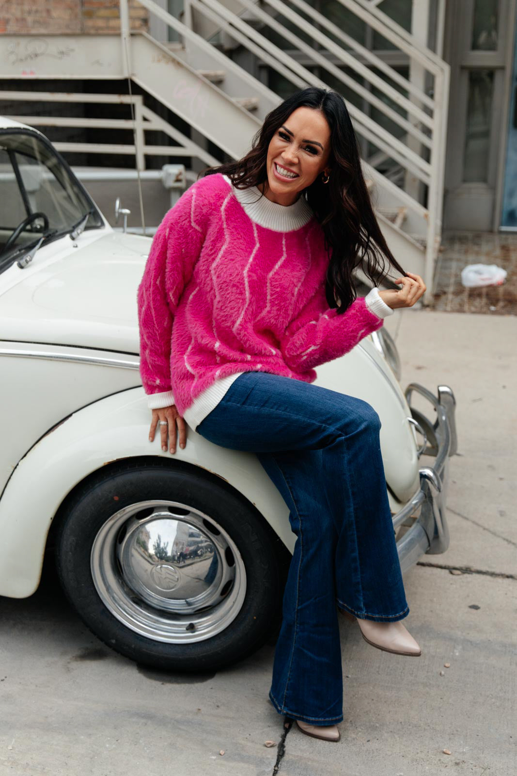 Bright pink Pop Culture Zig Zag Sweater with white collar and cuffs, displayed on a mannequin.