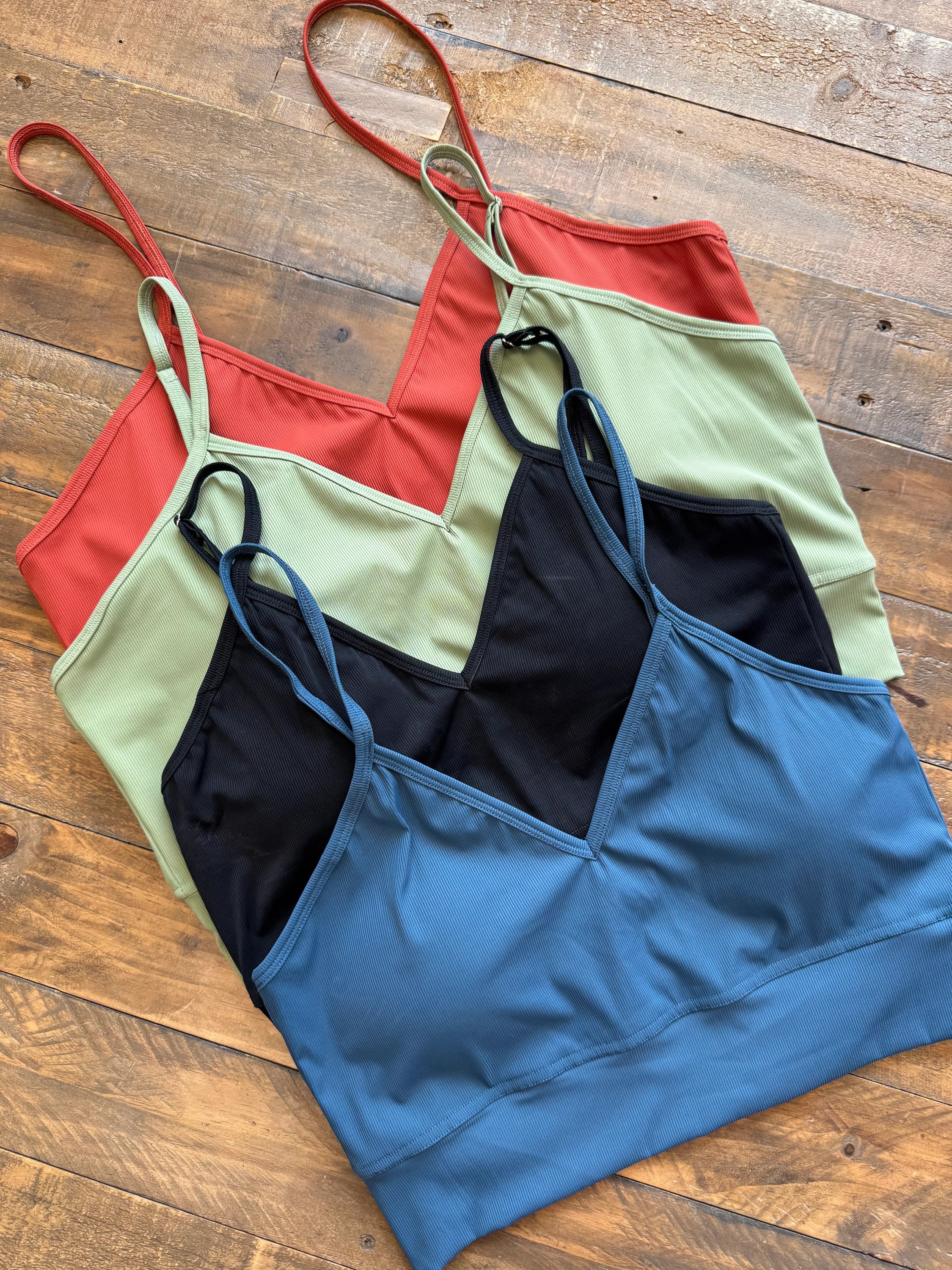 Devon Ribbed Bralette in four colors, showcasing adjustable straps and soft ribbed fabric.