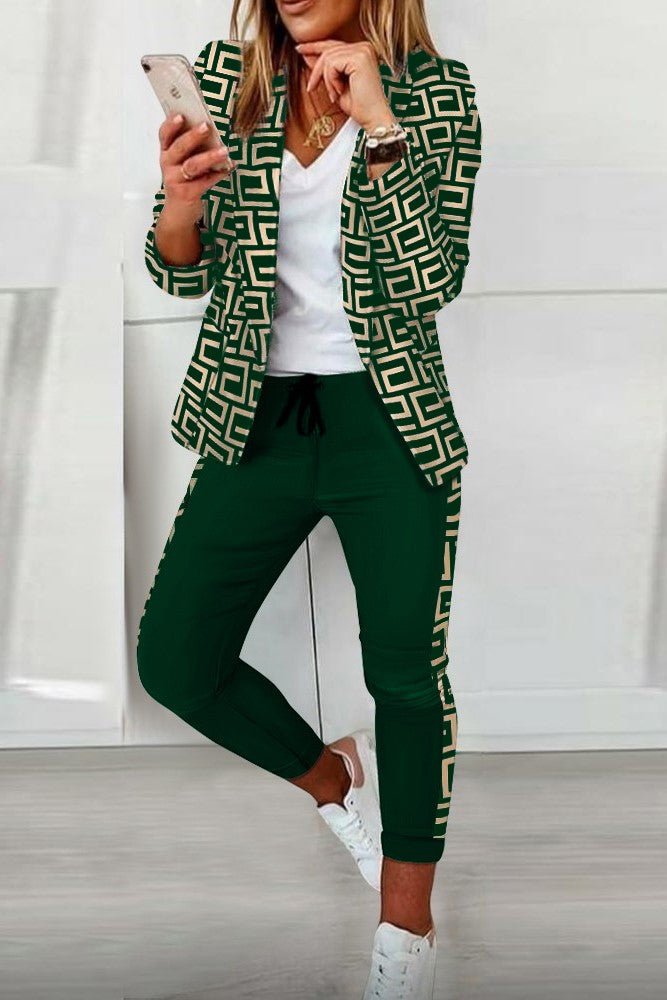Nunzia dark green print blazer and pants set featuring a geometric pattern, long sleeves, classic collar, and elastic waist pants with drawstring.