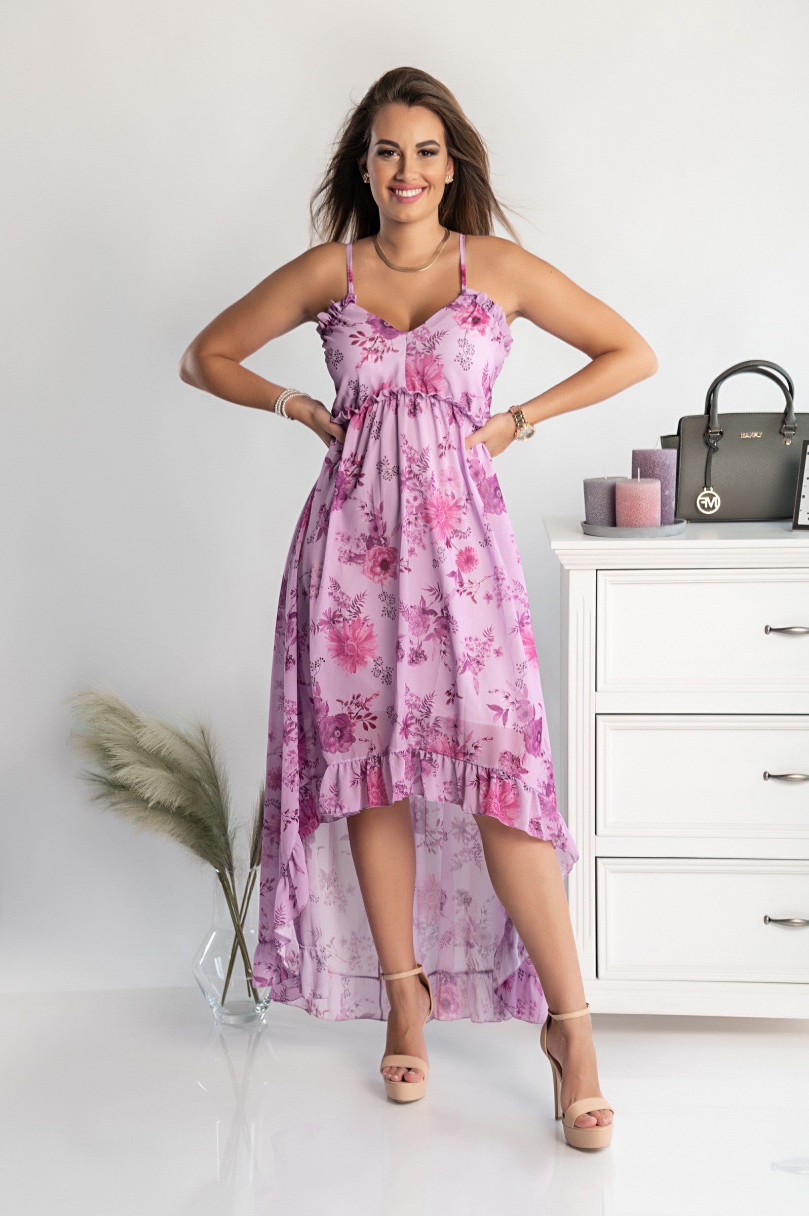 Elegant purple maxi dress with plunging neckline and ruffle trim, featuring spaghetti straps and an asymmetrical skirt with ruffles.