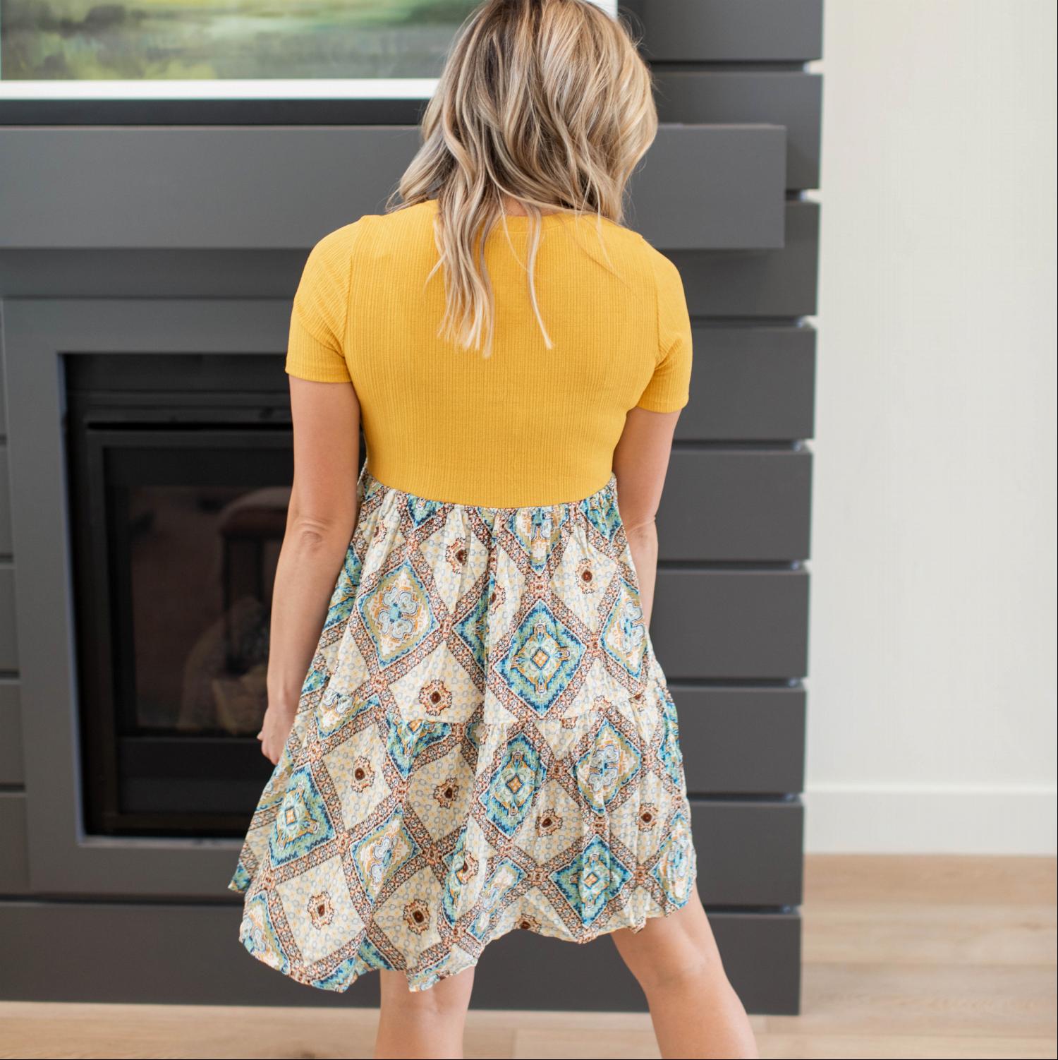 A stylish Printed Colorblock Tunic featuring a colorblocked design, short sleeves, and a fun print at the bottom, perfect for summer wear.