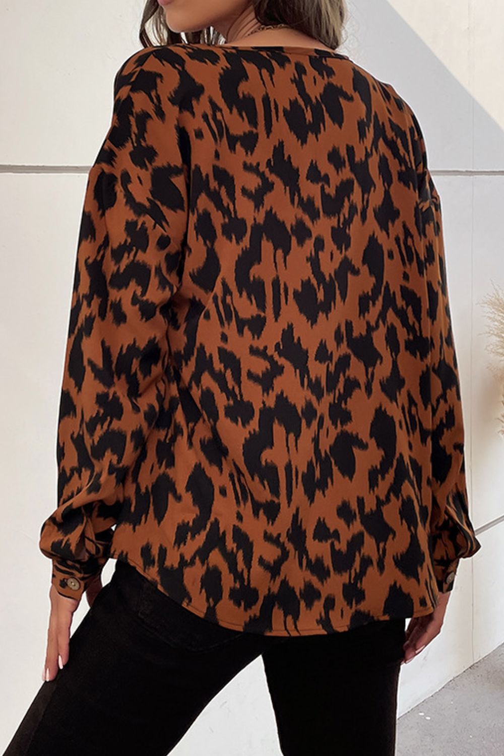 A stylish Printed Dropped Shoulder Button-Up Blouse featuring a round neck, long sleeves, and a trendy printed pattern, perfect for casual wear.