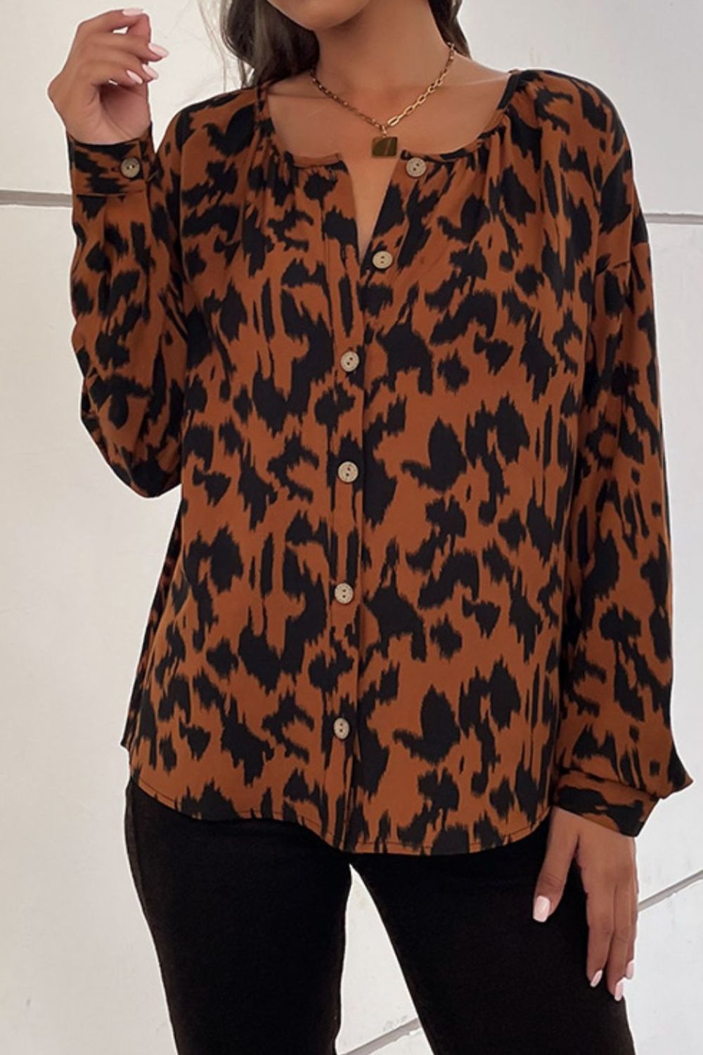 A stylish Printed Dropped Shoulder Button-Up Blouse featuring a round neck, long sleeves, and a trendy printed pattern, perfect for casual wear.