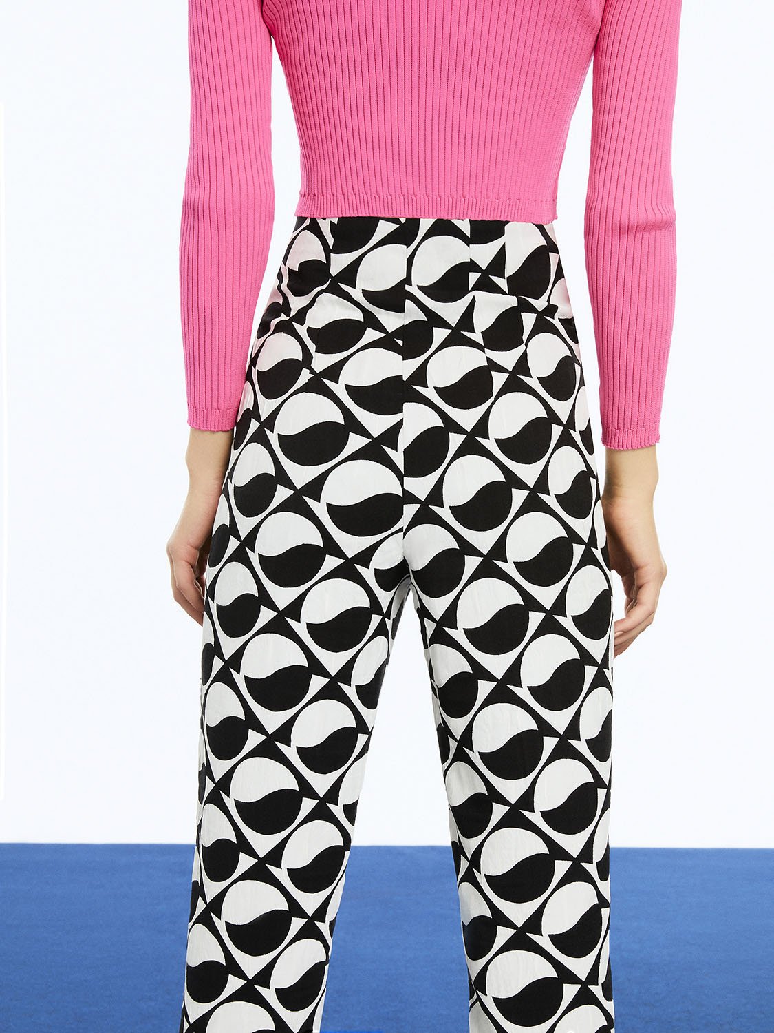 Stylish Printed High-Waisted Pants featuring a monochrome pattern with red and fuchsia accents, designed for a chic look.