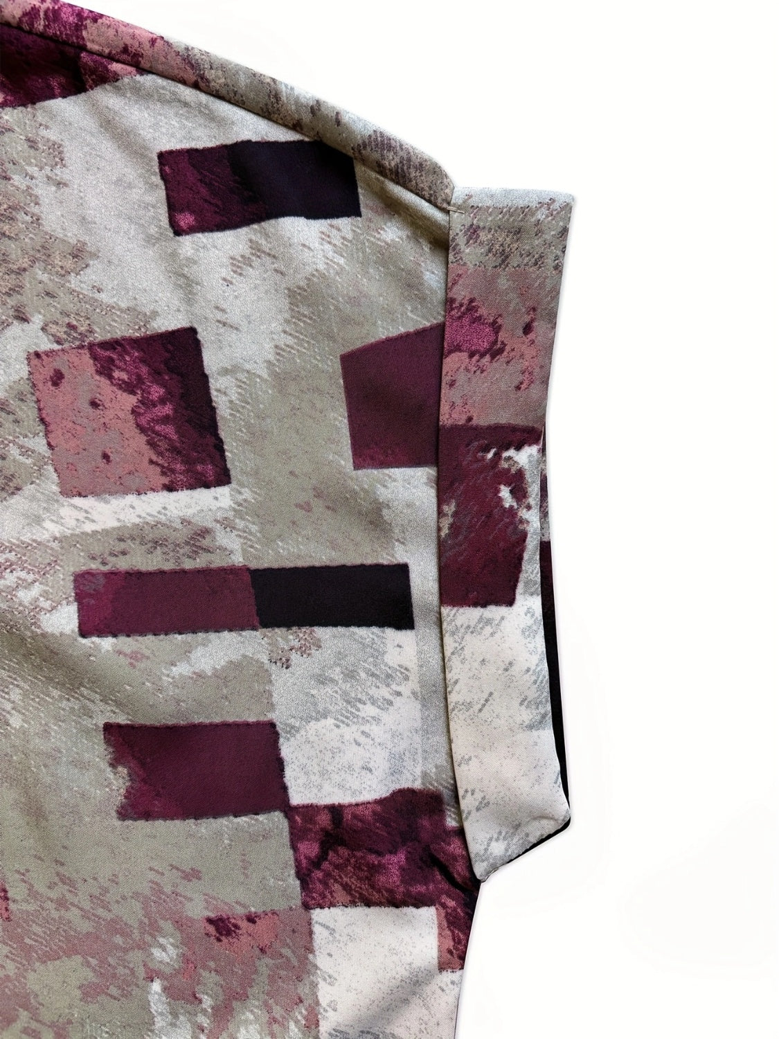 A stylish Printed Notched Short Sleeve Blouse featuring a chic neckline and short sleeves, made from a soft polyester blend.