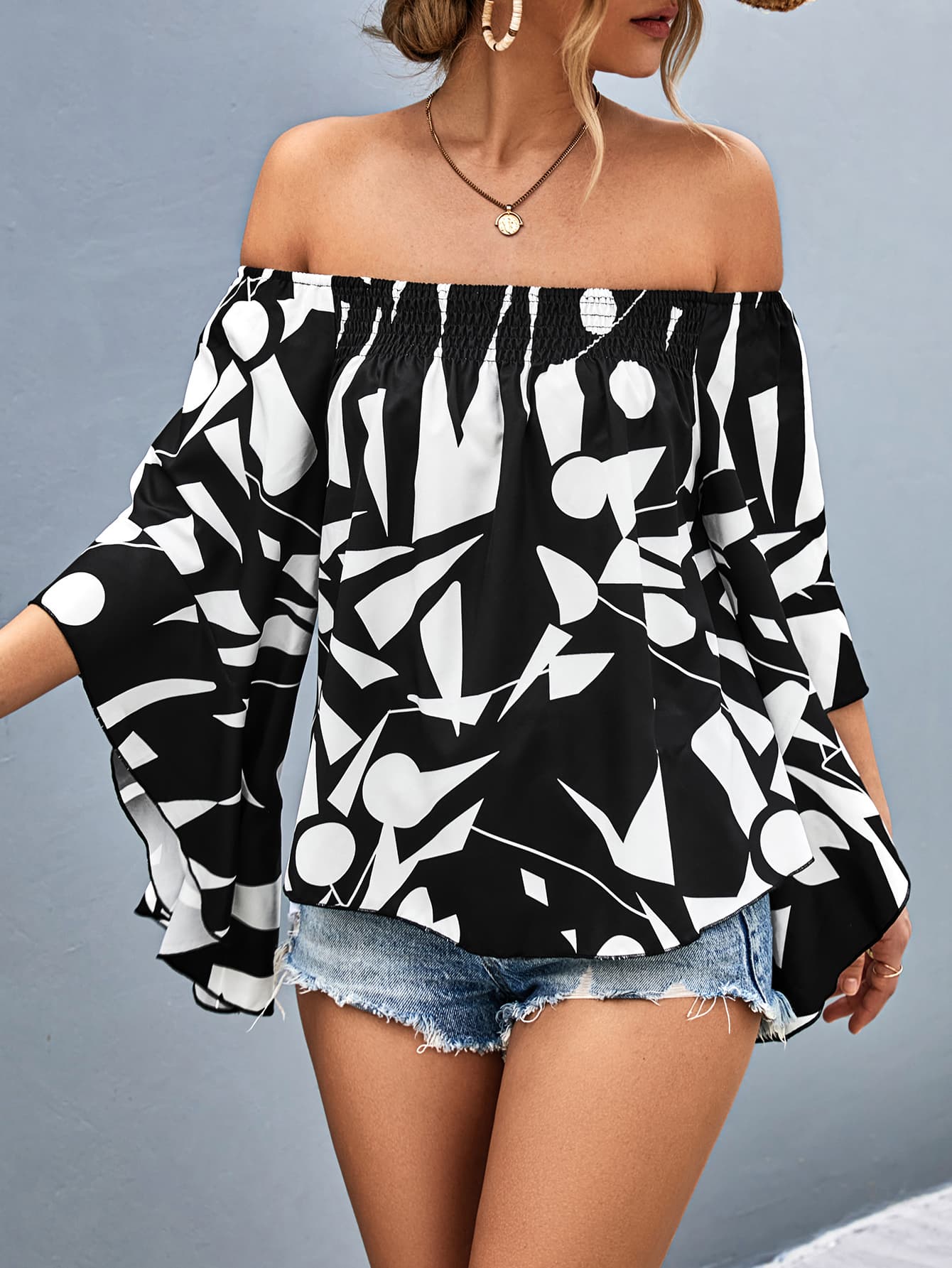 A stylish Printed Off-Shoulder Bell Sleeve Blouse featuring a chic geometric pattern, smocked design, and elegant bell sleeves.