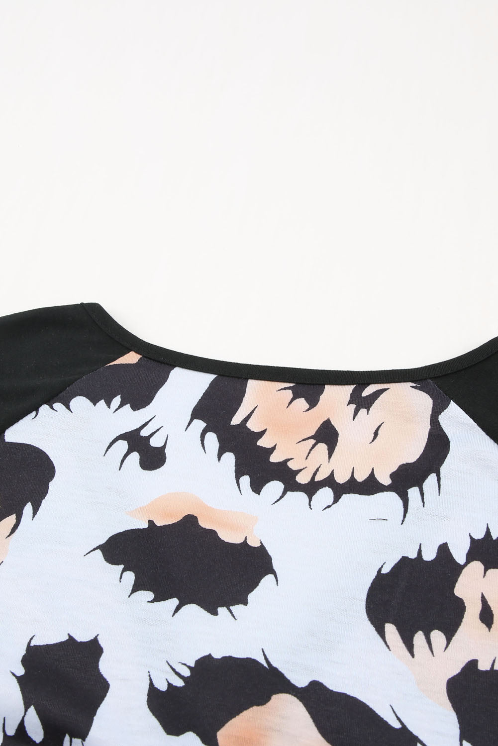 A stylish Printed Zip-Collar Short Raglan Sleeve Tee featuring a unique print, zip collar, and short sleeves, perfect for casual wear.