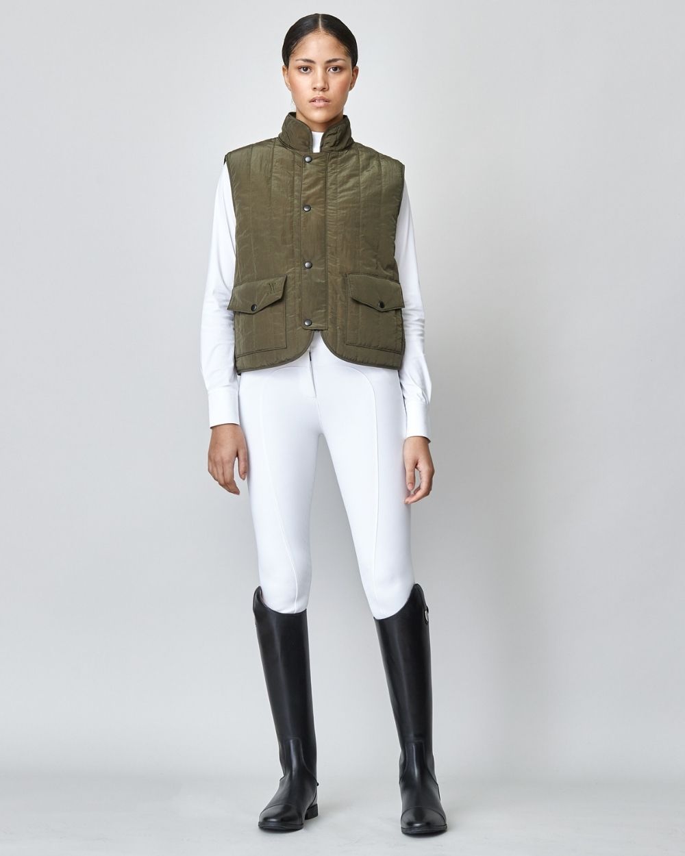 Green Quilted Riding Vest with stand-up collar and front zipper, featuring multiple pockets and embroidered logo.